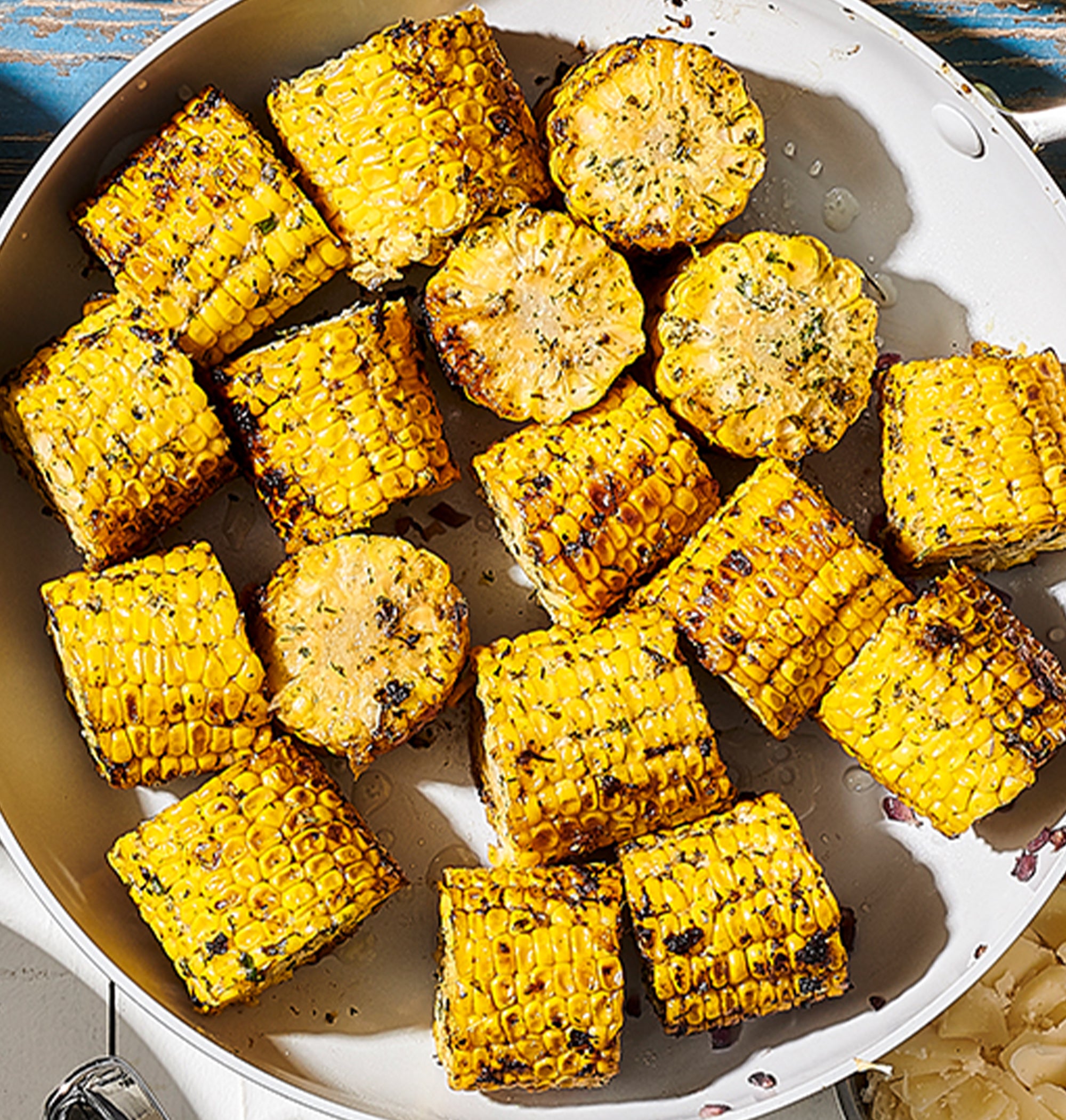 Short ears of sweet corn seasoned with cheese, horseradish, and herbs