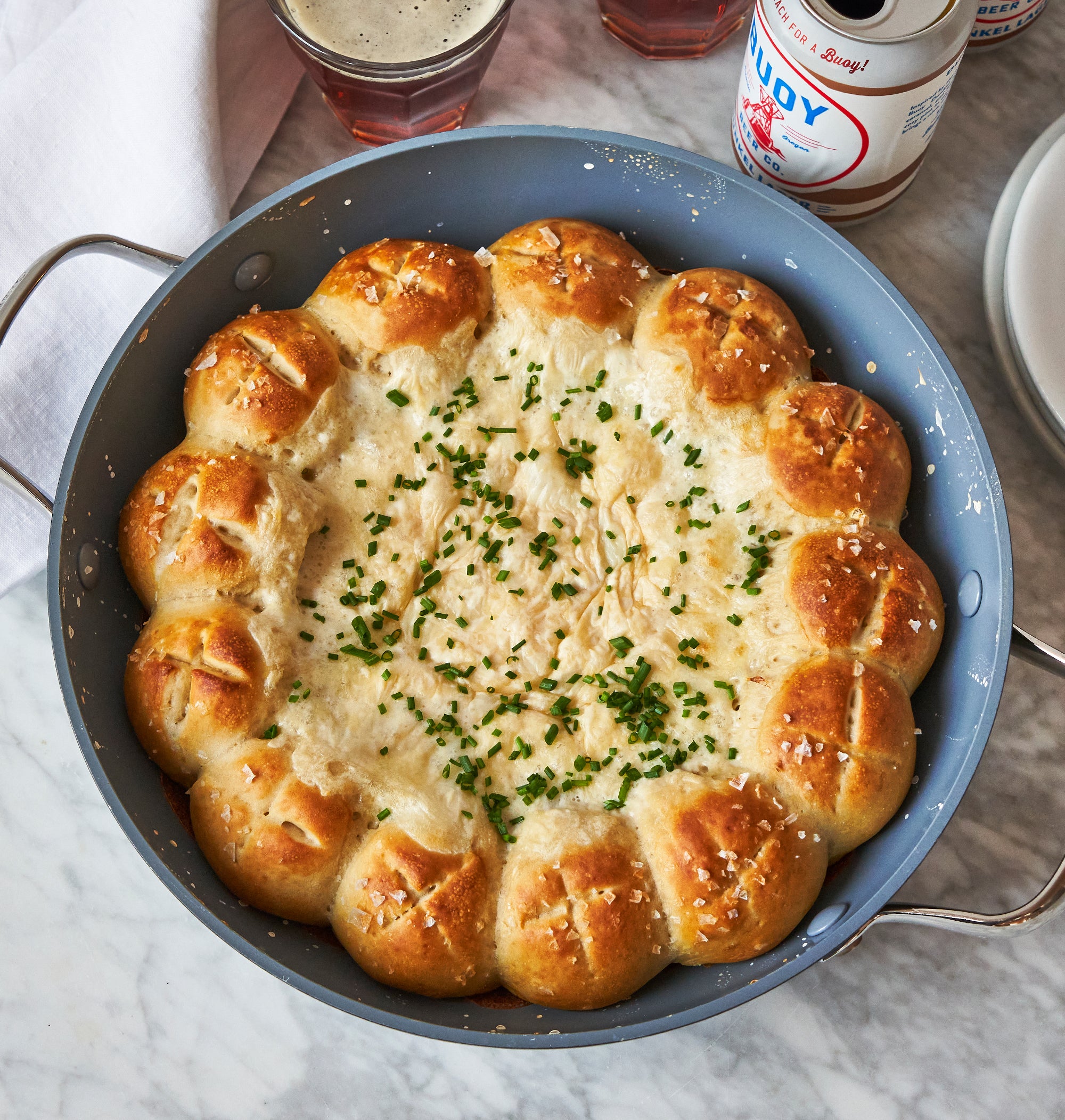 Skillet filled with pretzel bites and cheese dip
