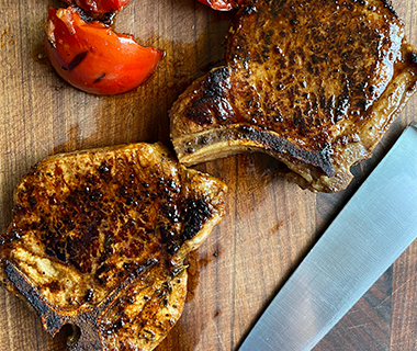 Black Pepper and Molasses Marinated Pork Chops with Grilled Tomatoes