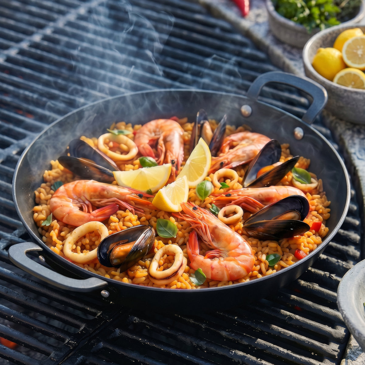 Seafood paella with shrimp and mussels cooking in a black carbon steel pan on a grill.