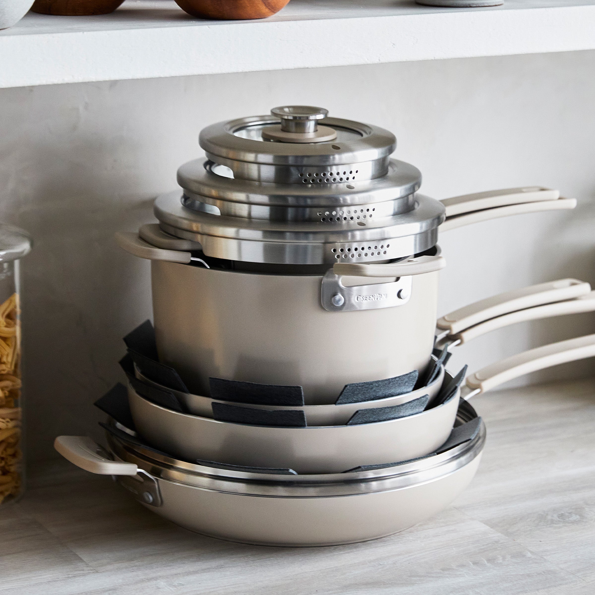 Stack of taupe cookware on a kitchen counter