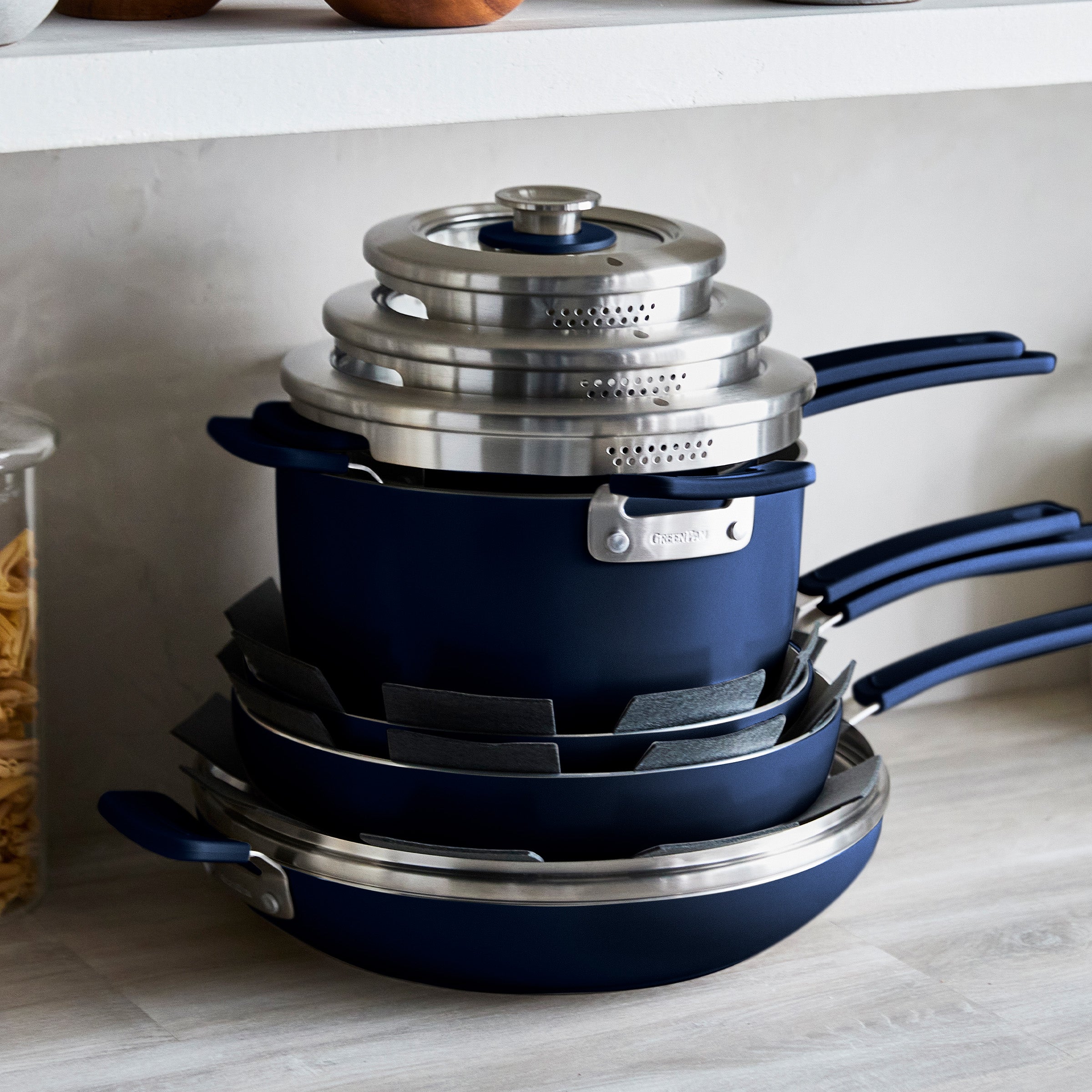 Stack of dark blue cookware on a kitchen counter