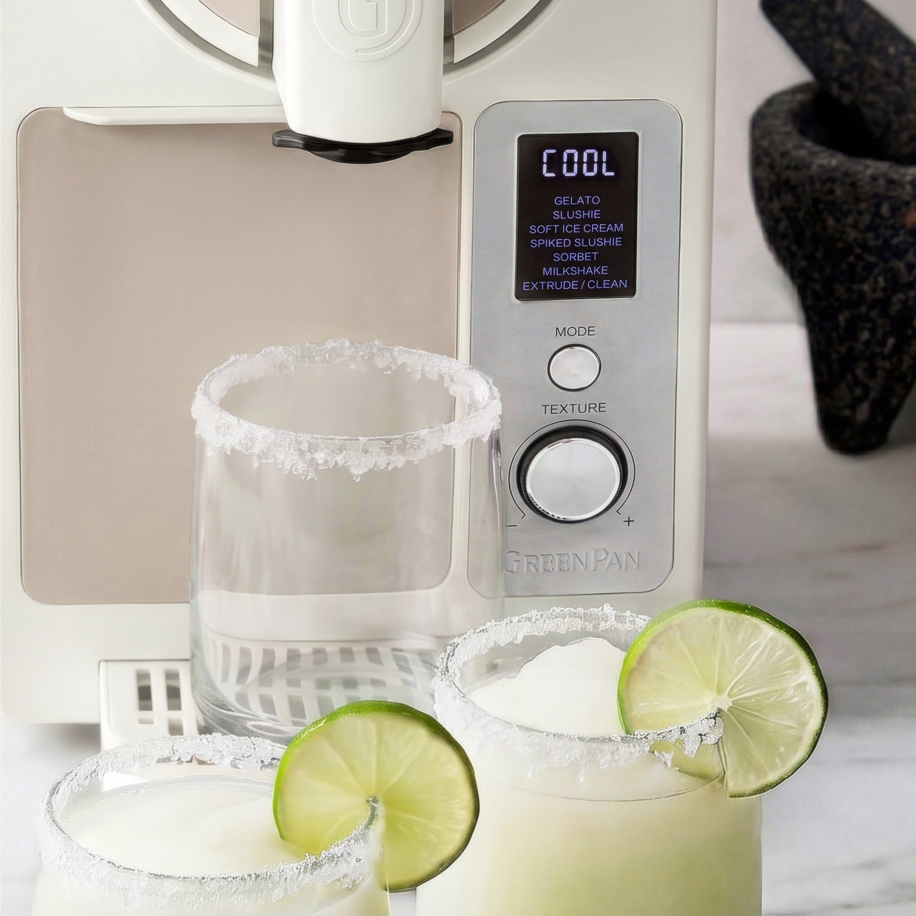 GreenPan ice cream maker with margarita glasses and lime slices on a kitchen counter