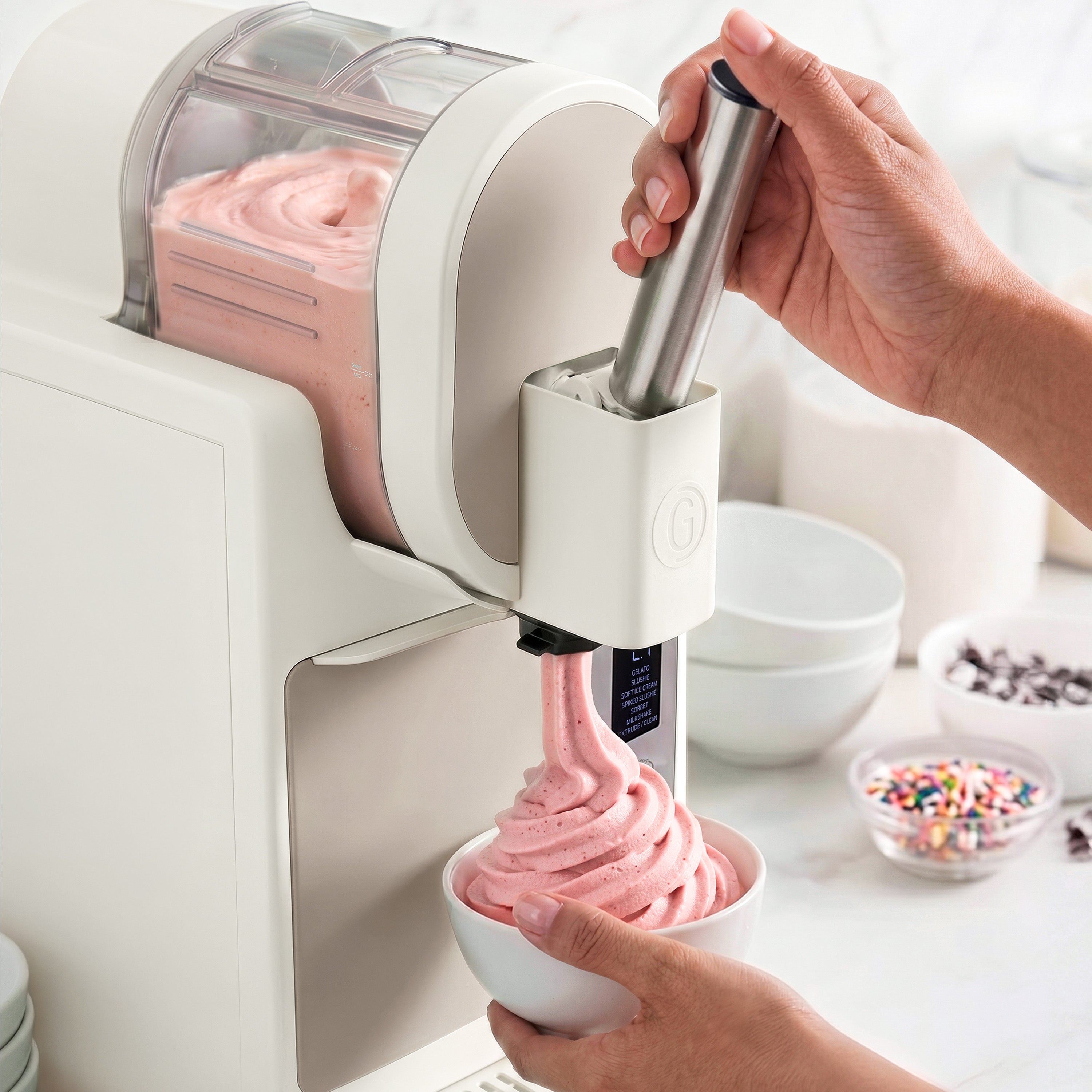 Ice cream maker dispensing pink ice cream into a bowl
