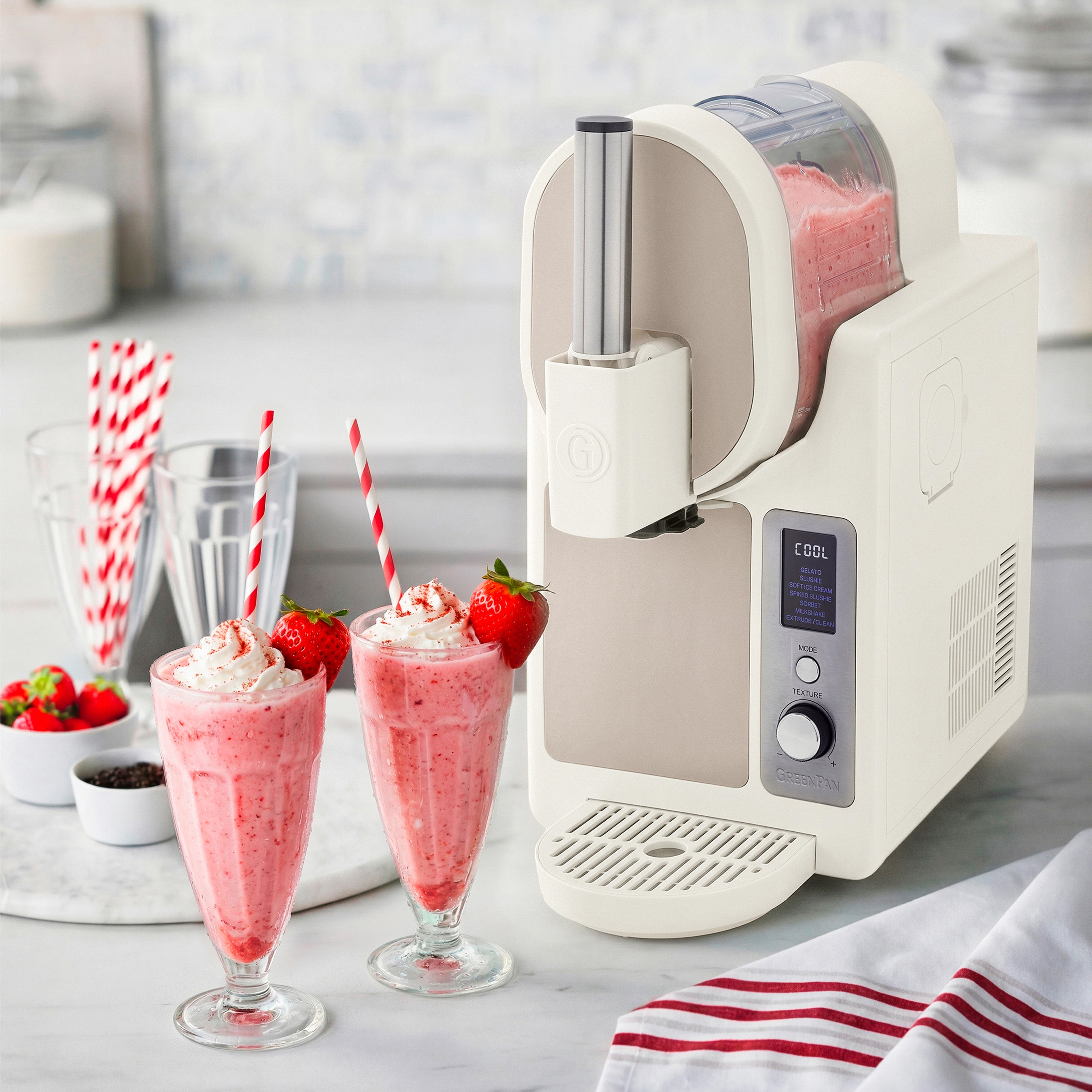 Ice cream machine with strawberry milkshakes on a kitchen counter