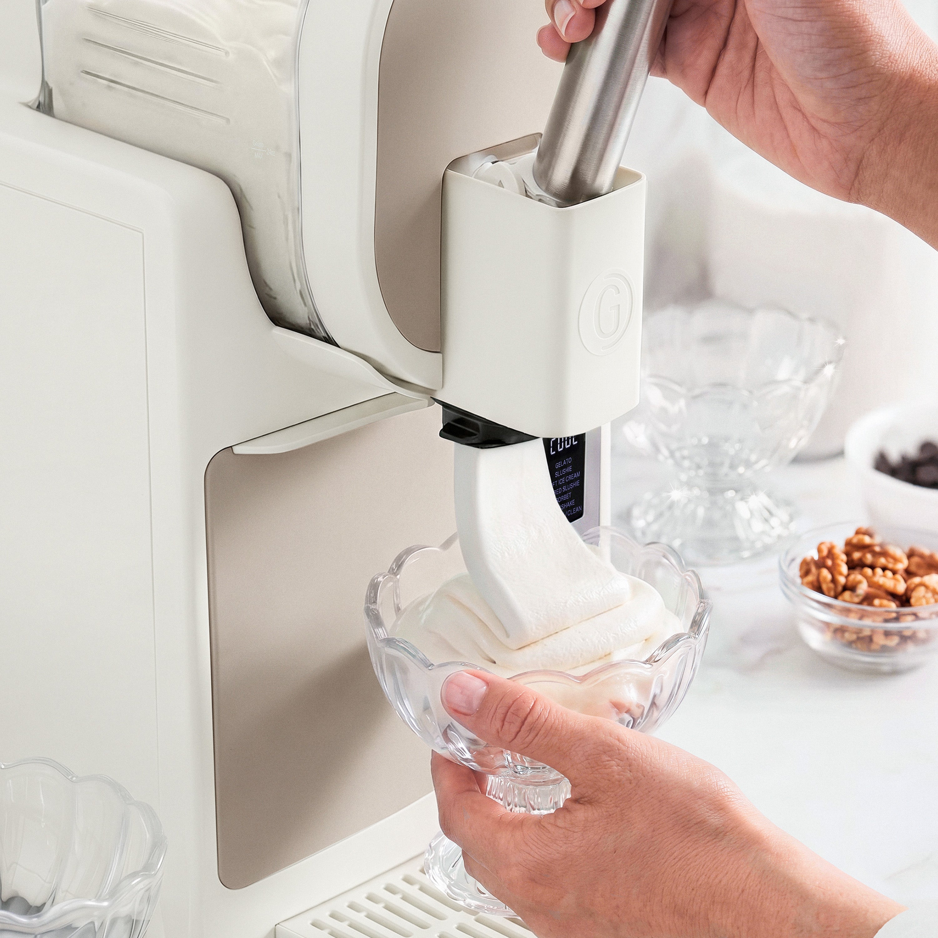 Ice cream maker in use with a bowl of ice cream being extracted.