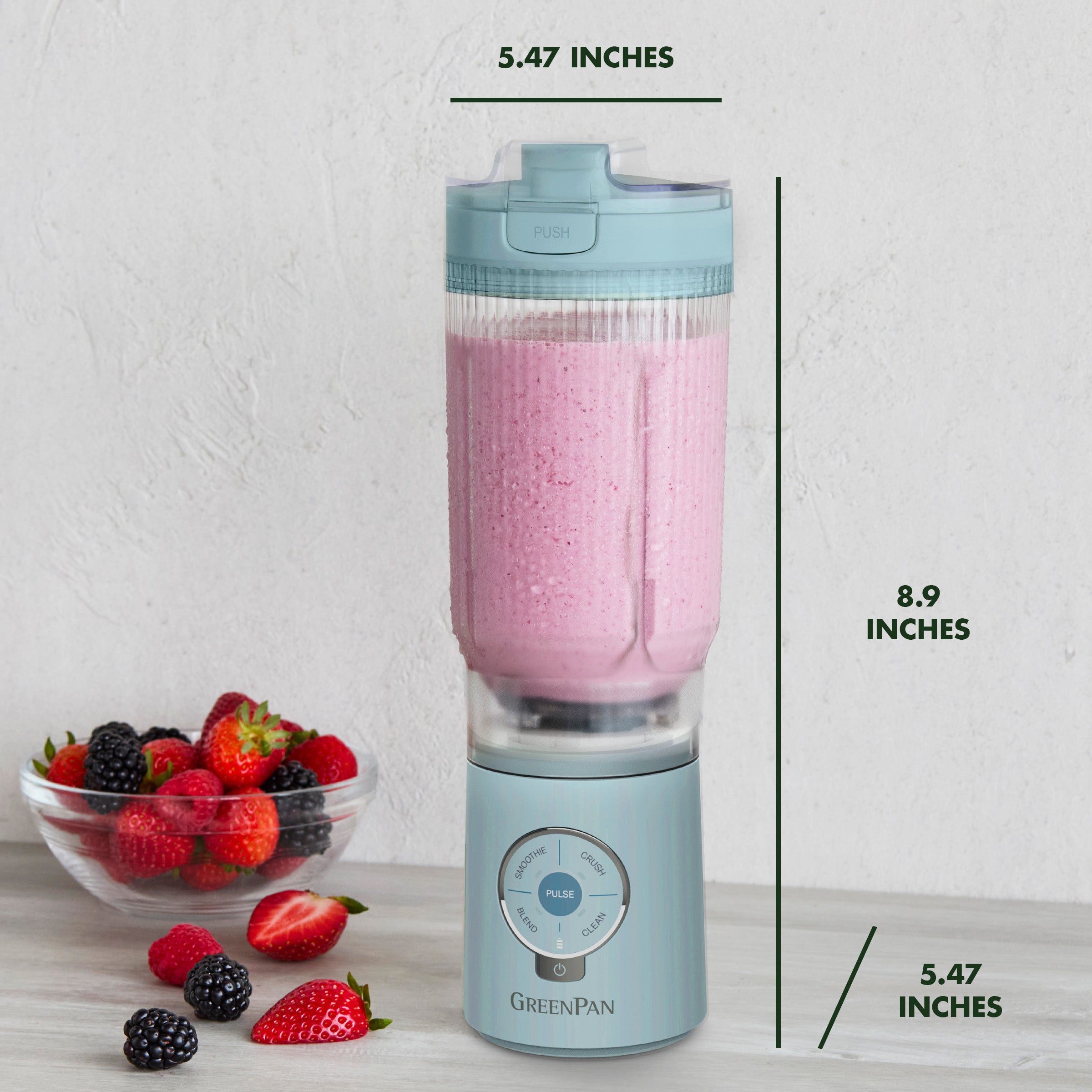 Portable blender with pink smoothie and berries on a white background, showing dimensions.