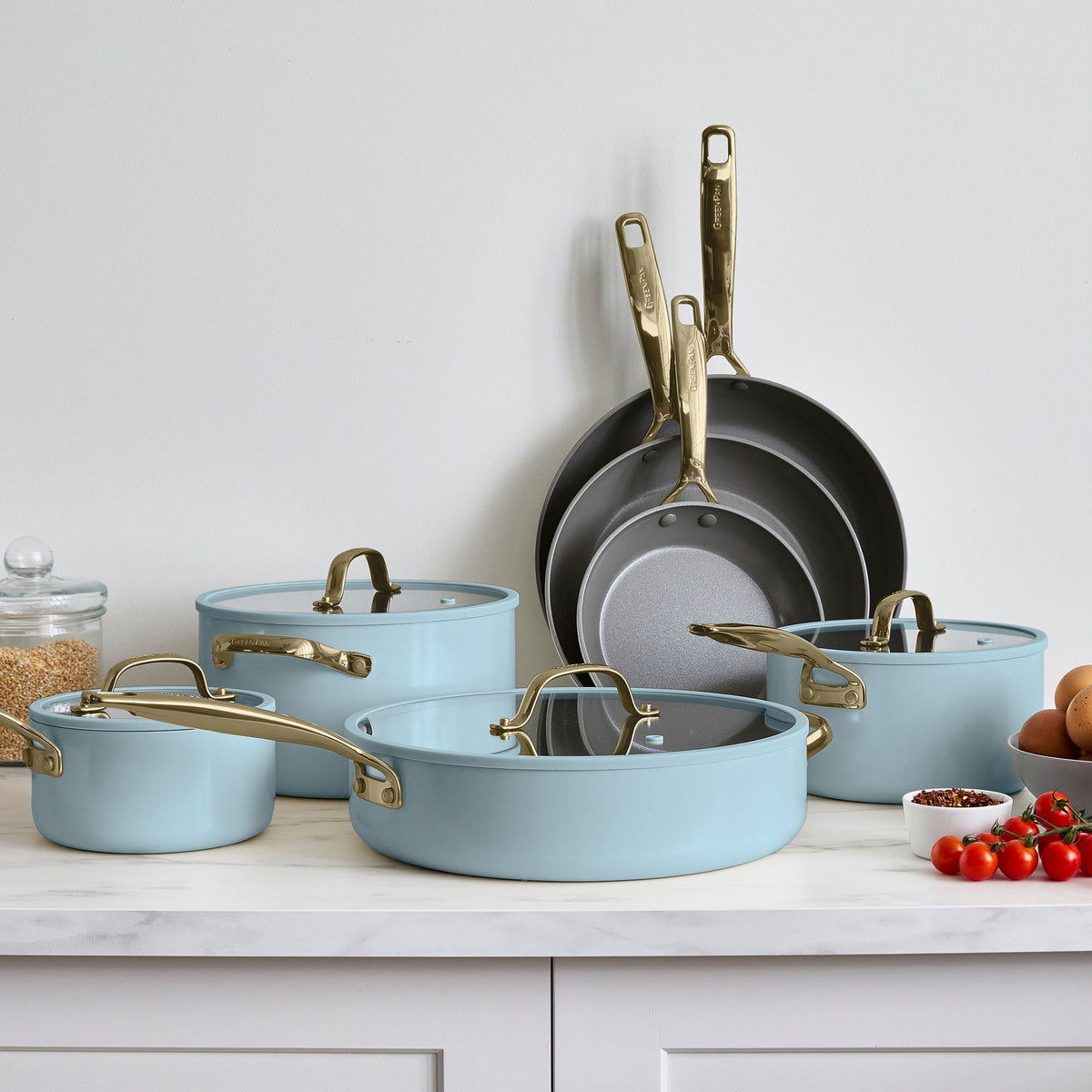 Light blue ceramic nonstick cookware set with gold handles, 11 pieces displayed together.