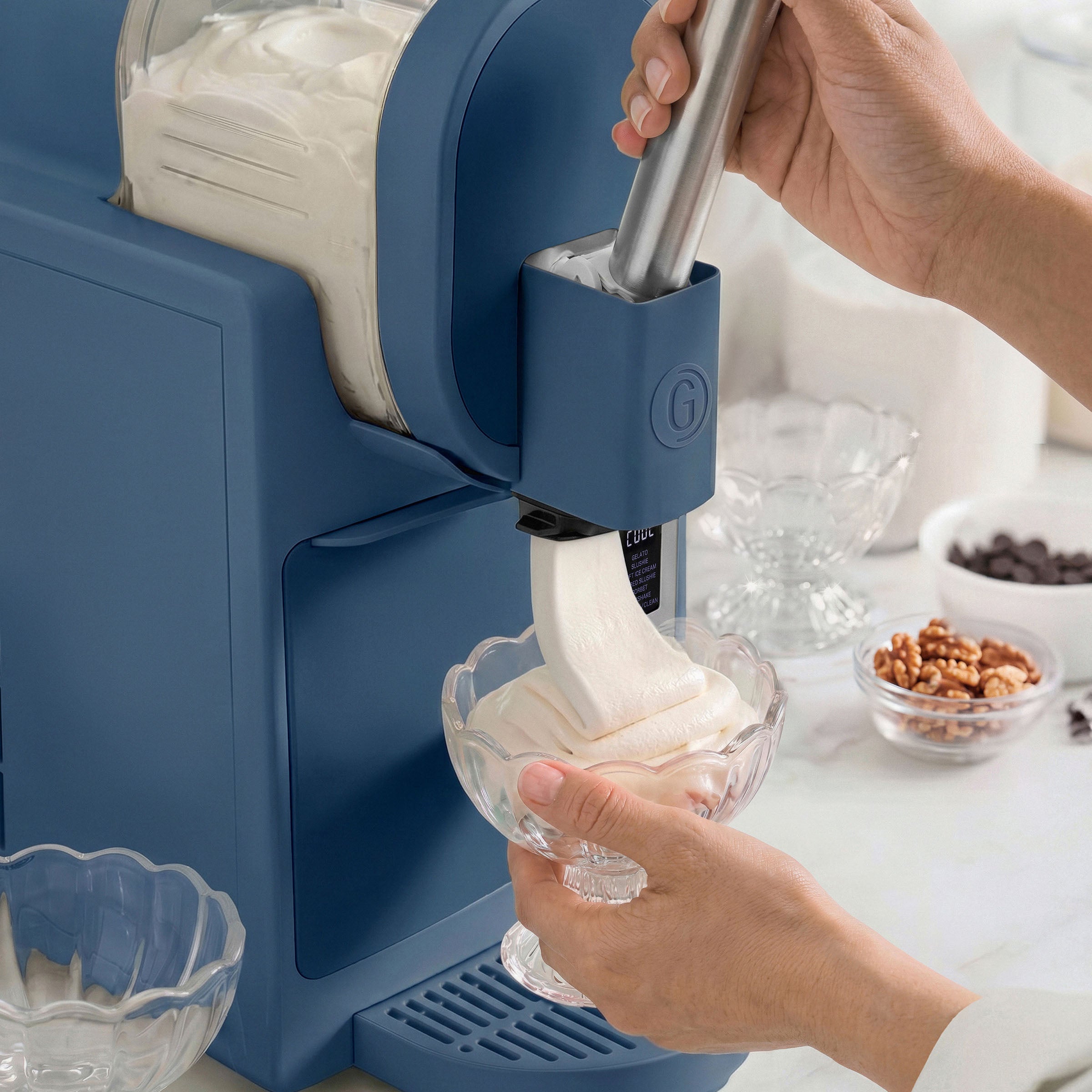 Ice cream maker in use with a bowl of ice cream being extracted.
