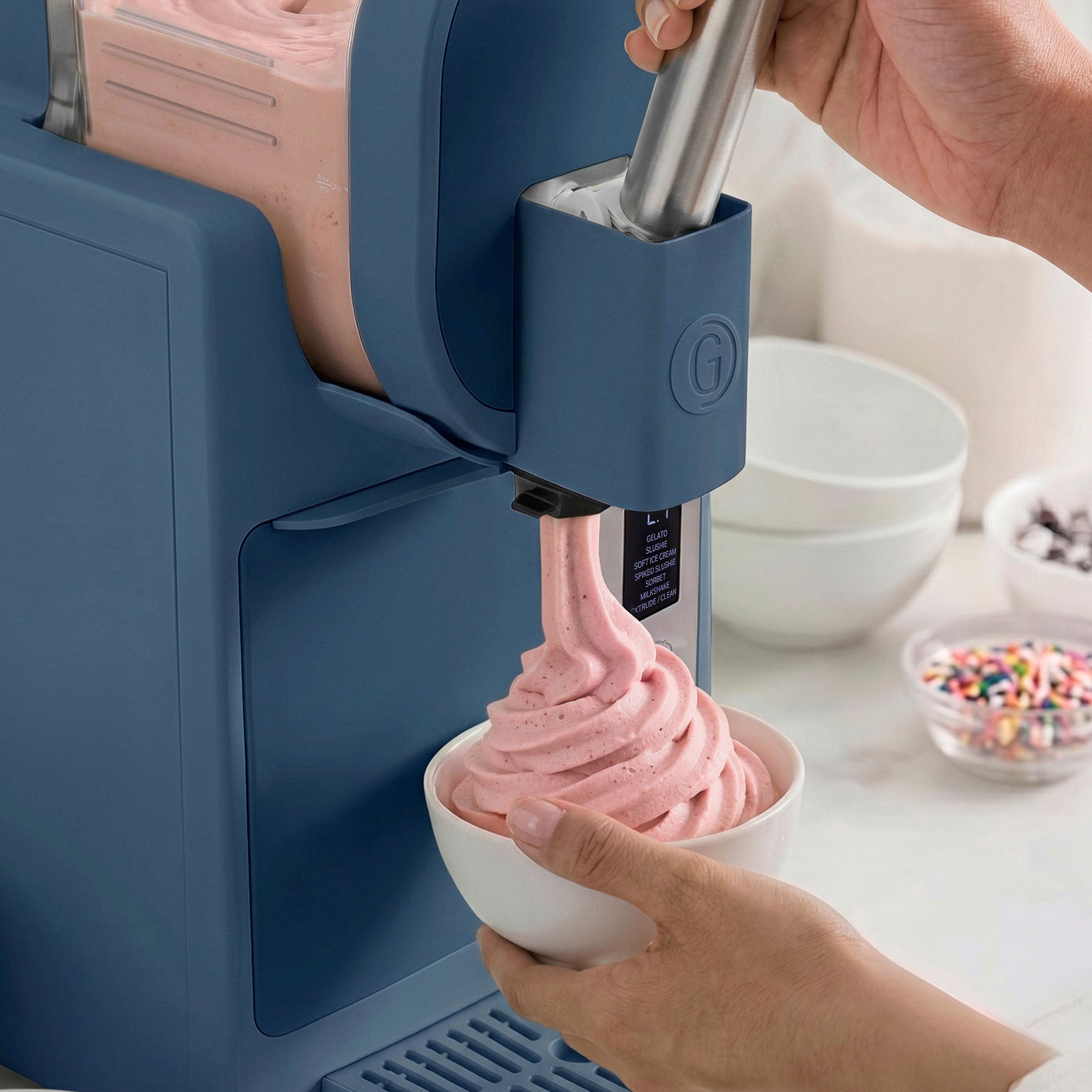 Ice cream maker dispensing pink ice cream into a bowl