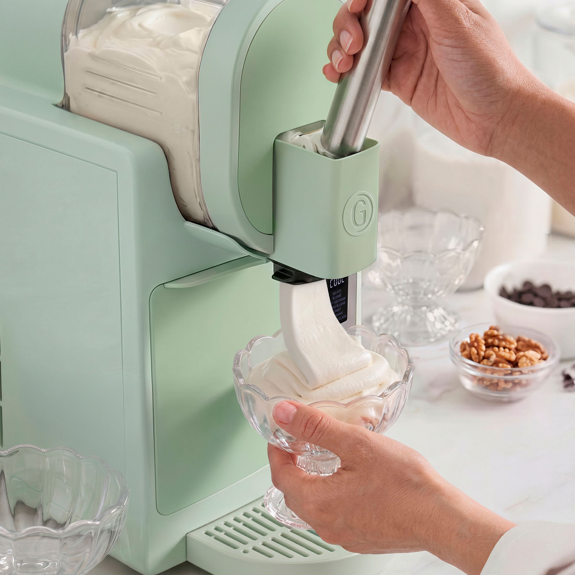 Ice cream maker in use with a bowl of ice cream being extracted.