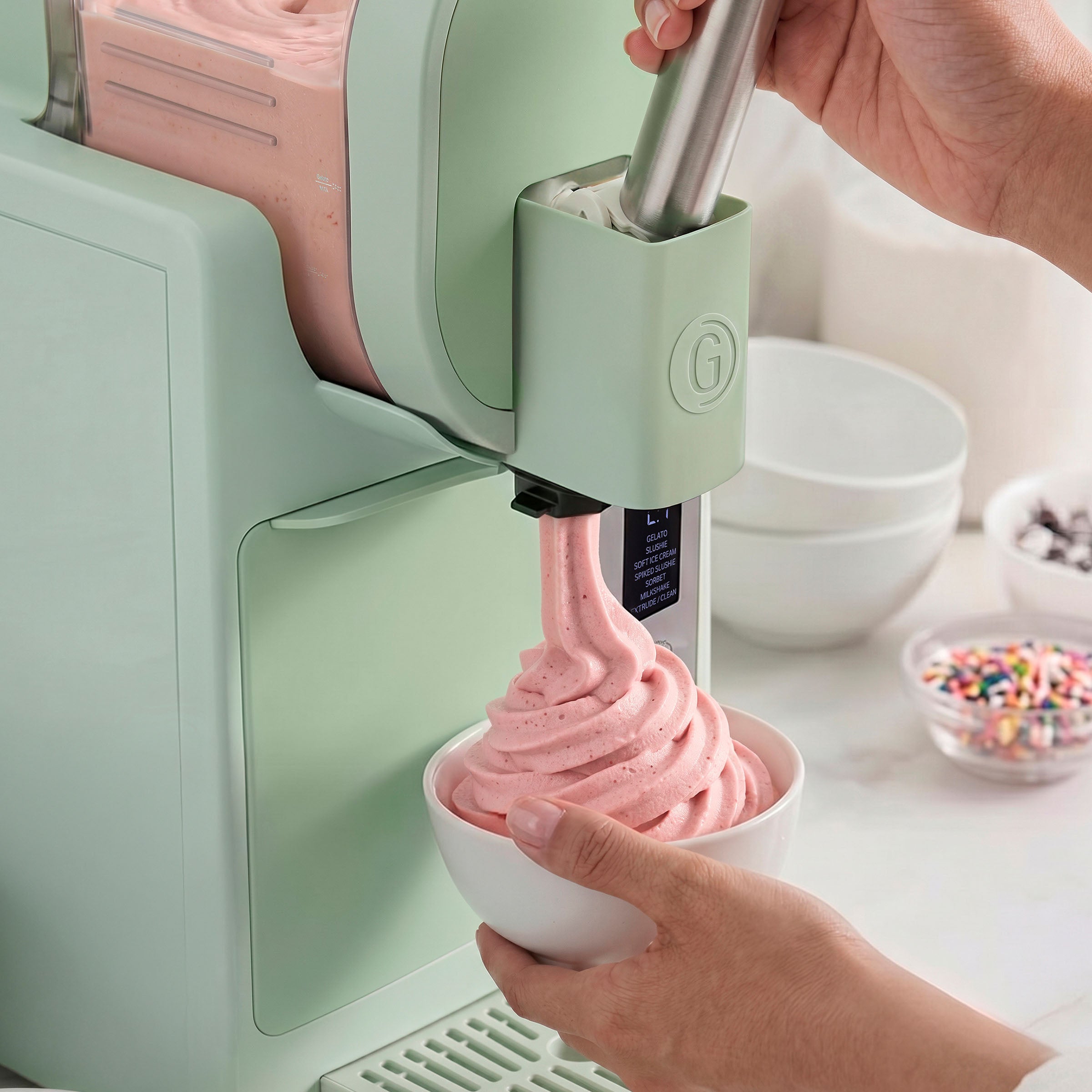 Ice cream maker dispensing pink ice cream into a bowl