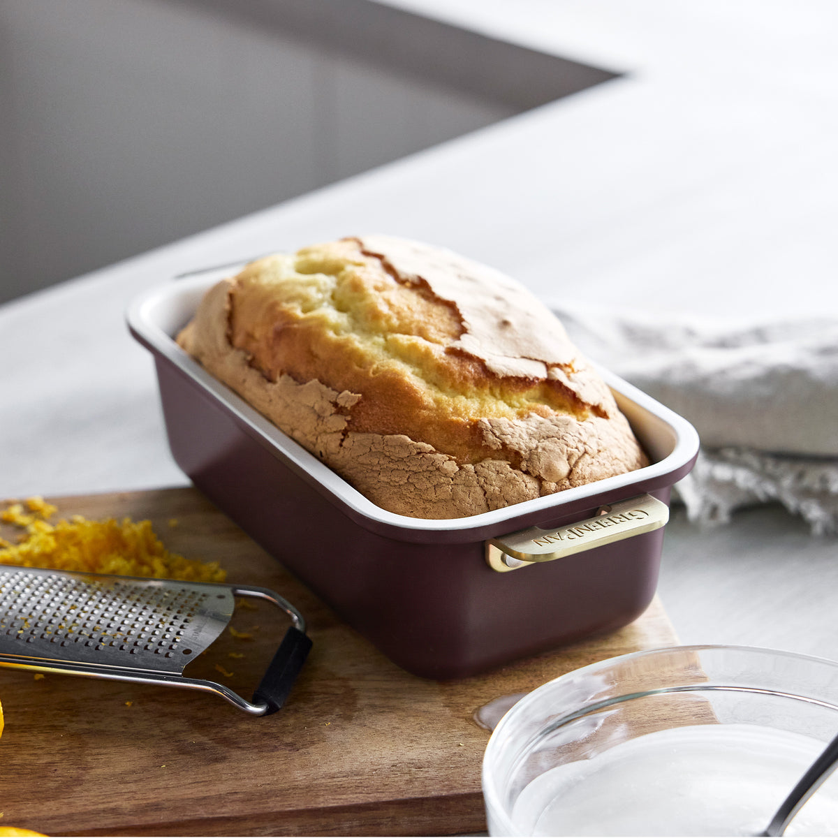 Loaf of bread in a Bordeaux Reserve Bakeware 7-piece rectangular pan with gold-tone handles.