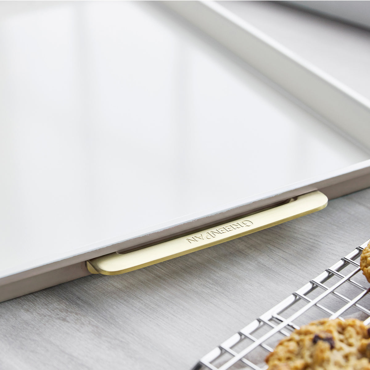 Latte-colored aluminized steel half sheet pan, 13″ x 18″, with gold-toned metal handles.