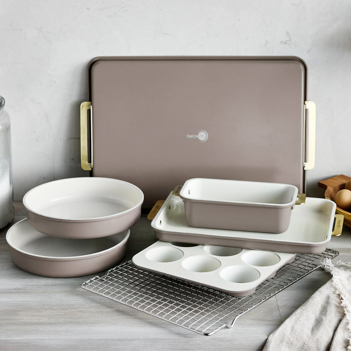 Reserve Bakeware 7-piece set in latte-colored heavy-gauge aluminized steel with light-colored interiors.