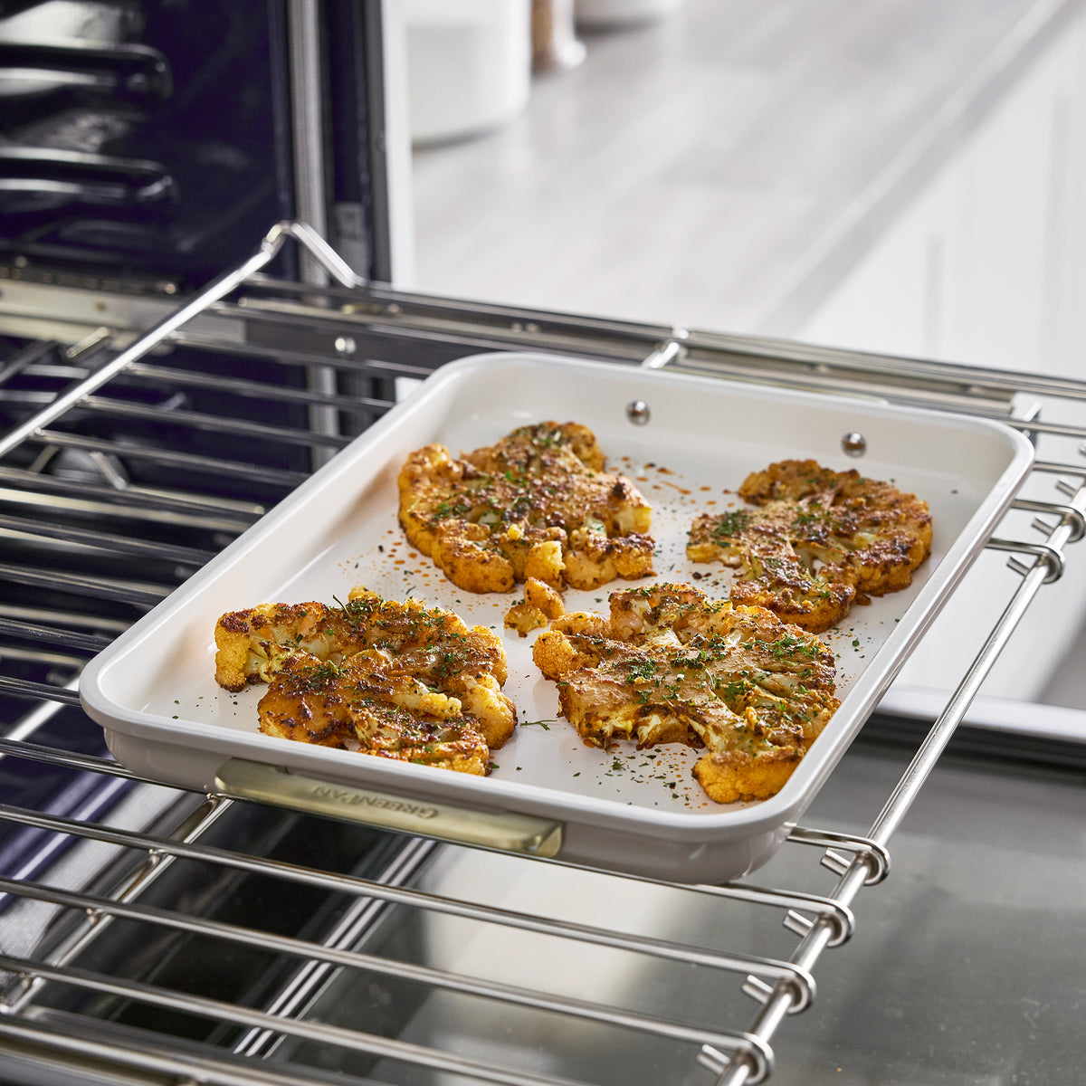 Roasted cauliflower in a Latte Reserve Bakeware 7-piece set baking pan on an oven rack.
