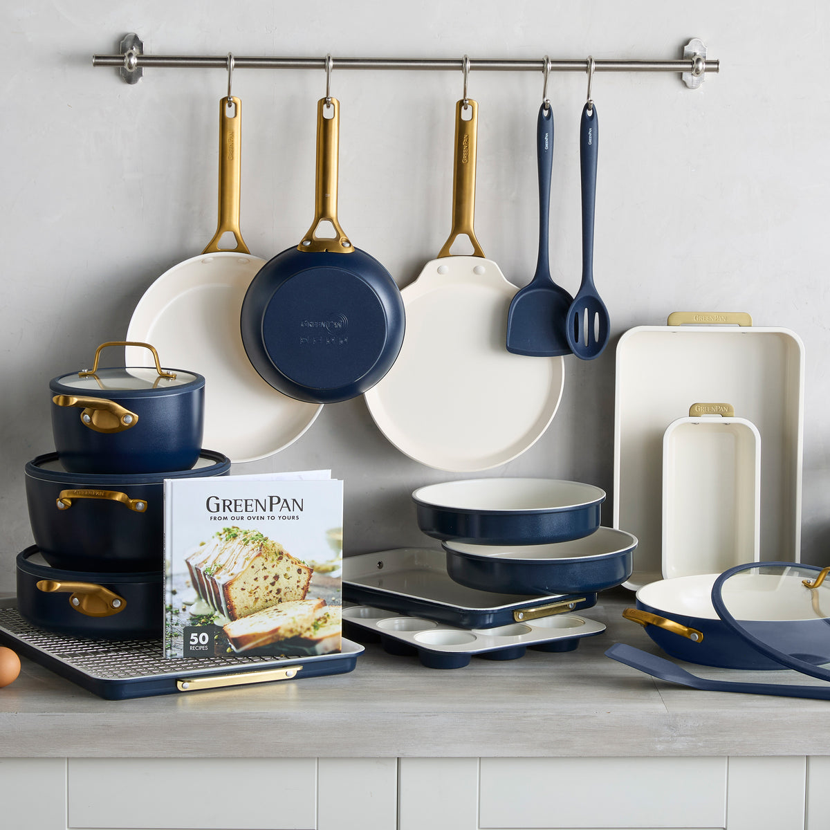 Reserve Pro 22-piece cookware and bakeware set in twilight blue and cream with gold-tone handles.