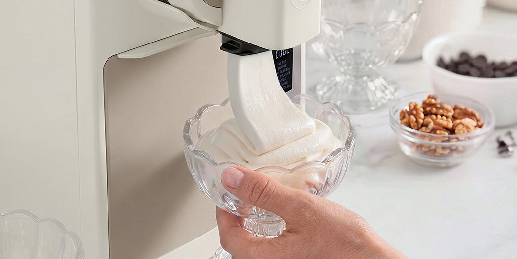 Hand holding a glass under a Frost Pro  machine dispensing Gelati.