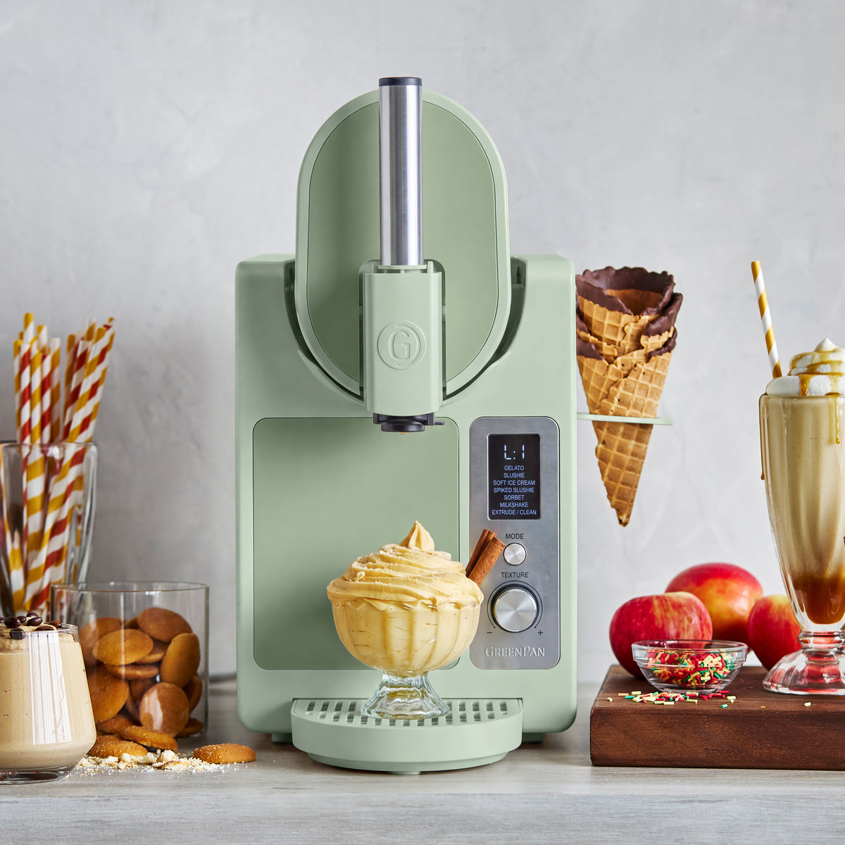 Pistachio green Frost Pro 16-in-1 machine serving soft ice cream into a glass, surrounded by cones, shakes, cookies, and treats.