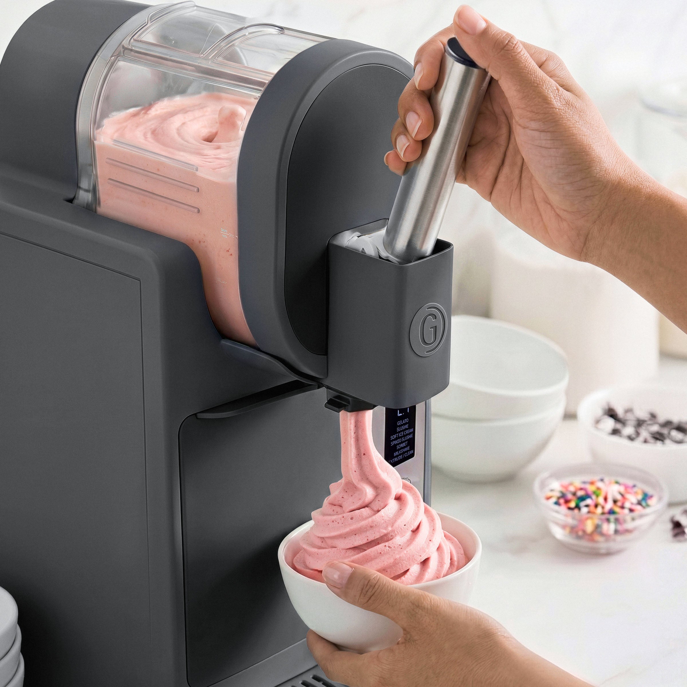 Ice cream maker dispensing pink ice cream into a bowl