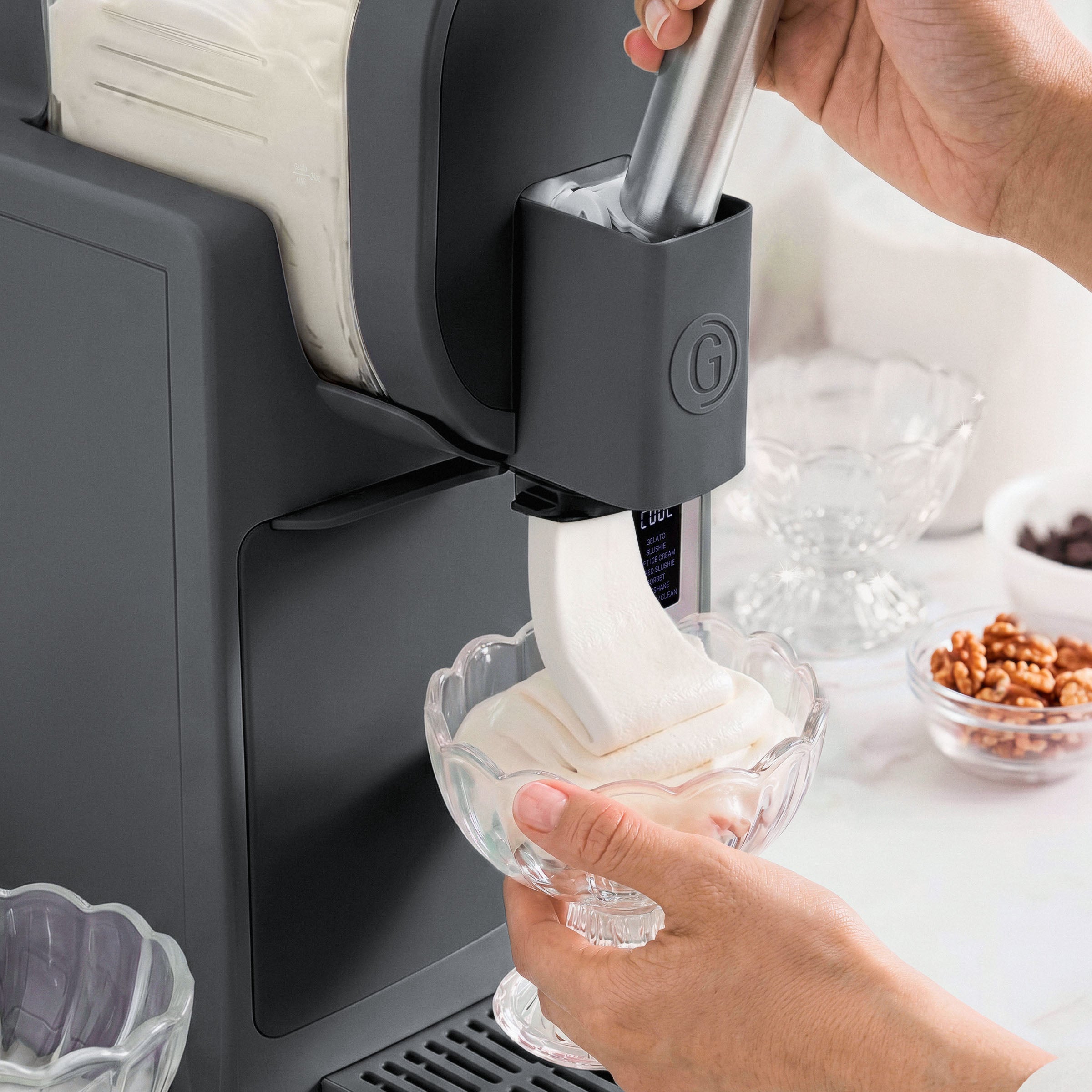Ice cream maker in use with a bowl of ice cream being extracted.