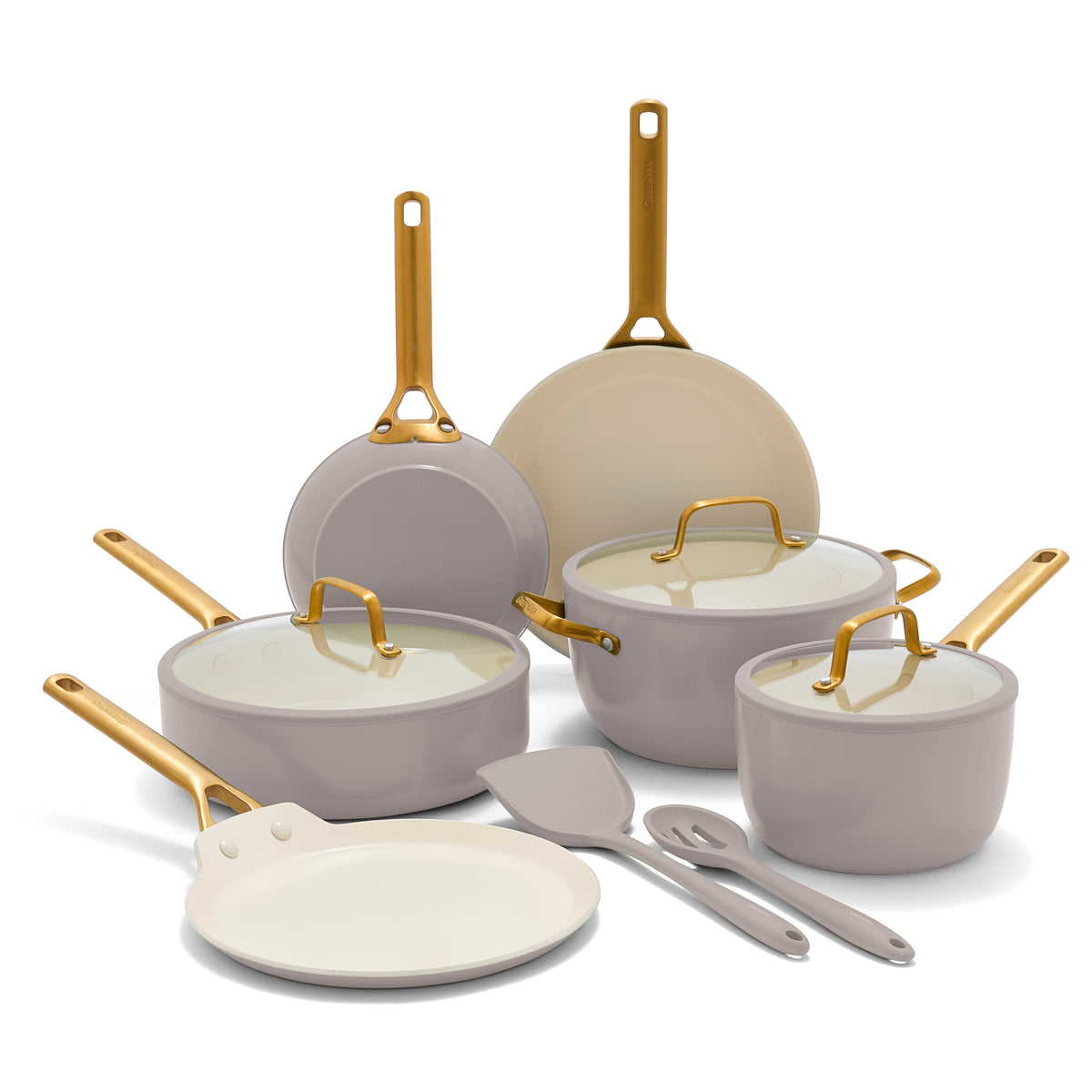 Set of cookware with gold handles on a white background