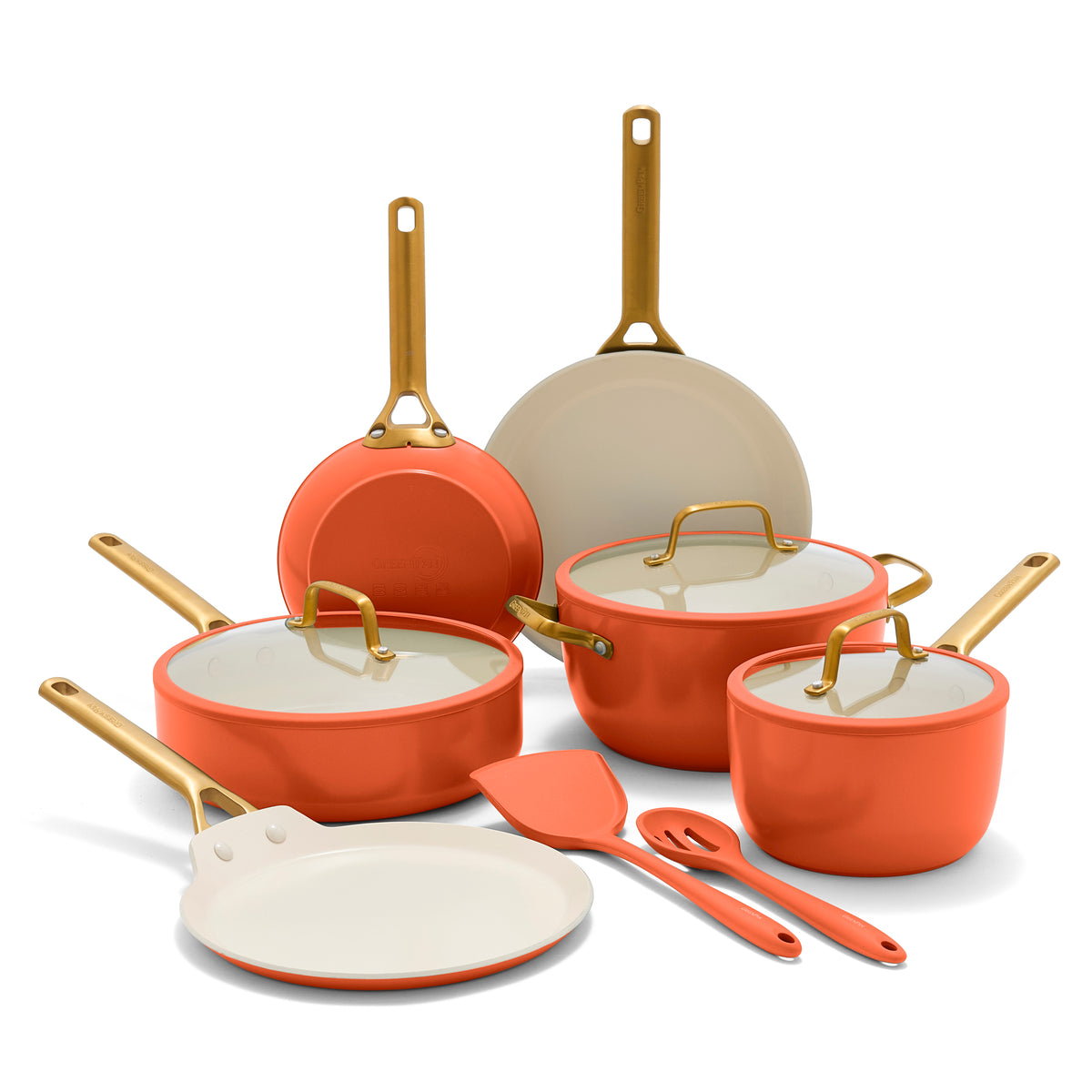 Set of orange cookware with gold handles on a white background