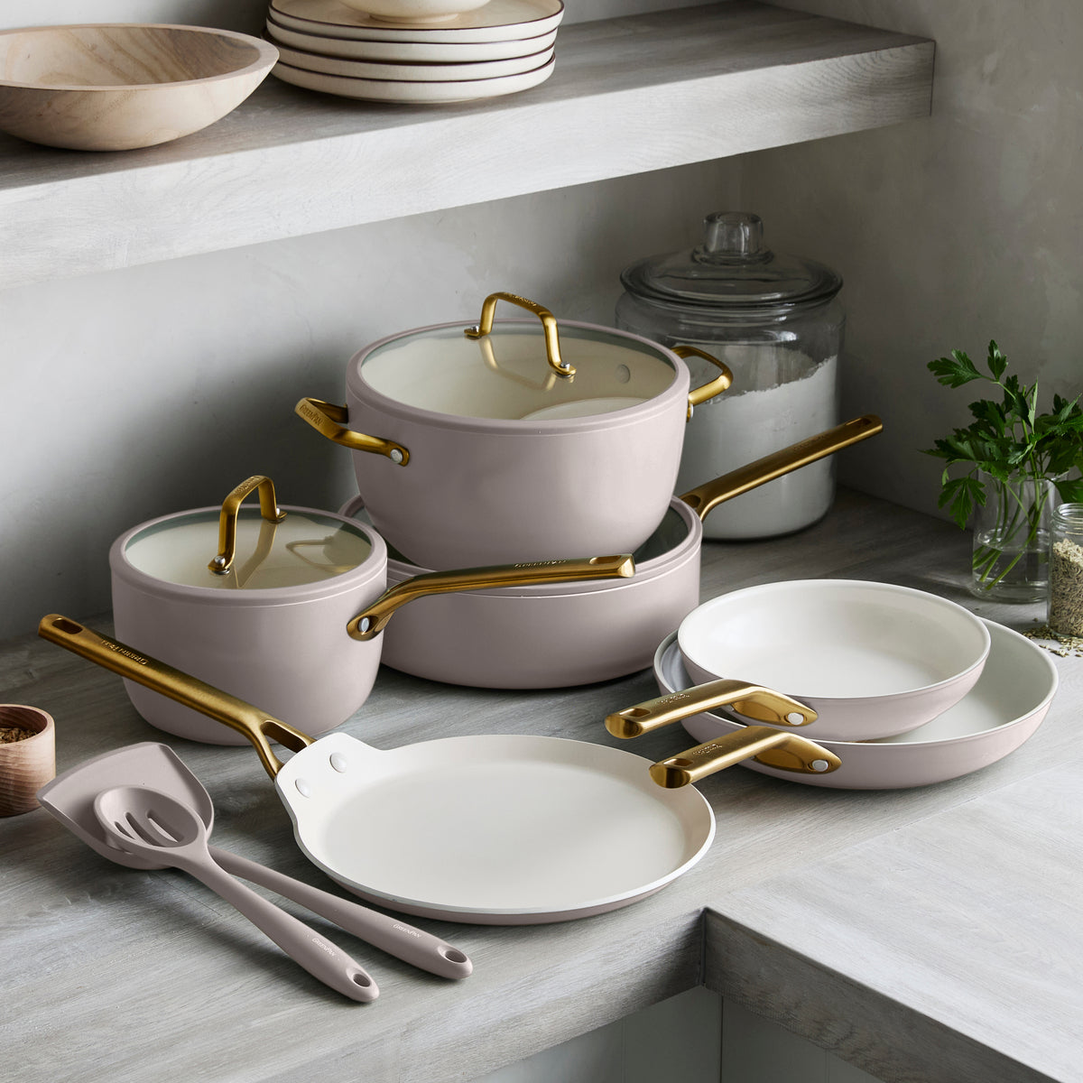 Set of cookware with gold handles on a kitchen counter