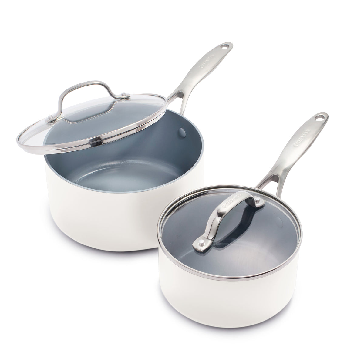 Cream ceramic nonstick saucepan set, two sizes with lids, one open and one closed, on a white background.