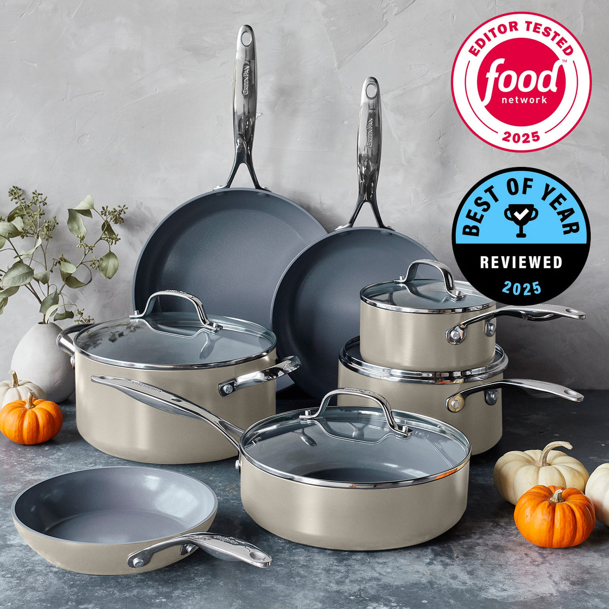 Taupe ceramic nonstick 11-piece cookware set with glass lids arranged on a kitchen counter.