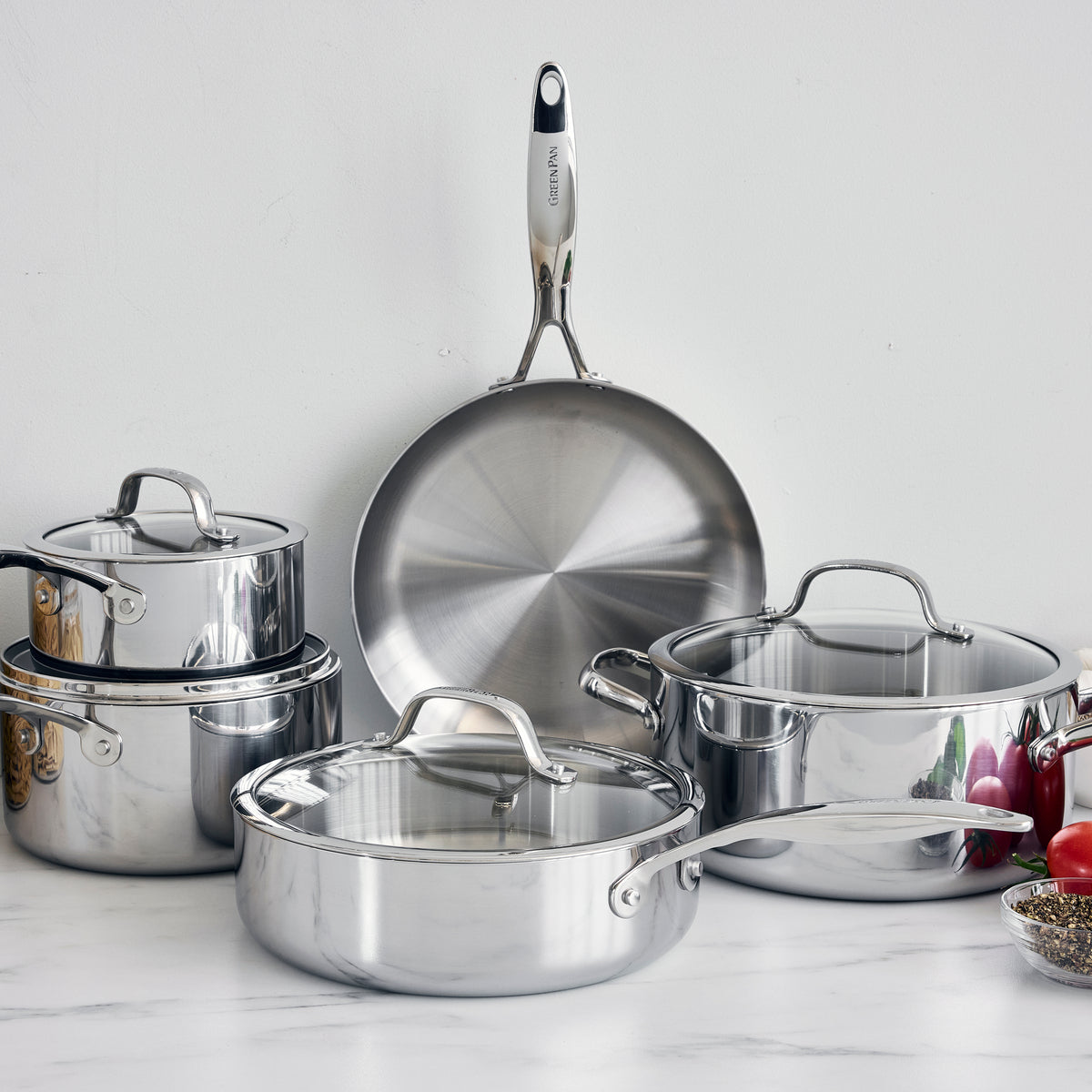 Valencia Pro 9-piece stainless steel uncoated cookware set including a frying pan, pots, and a sauté pan with lids.