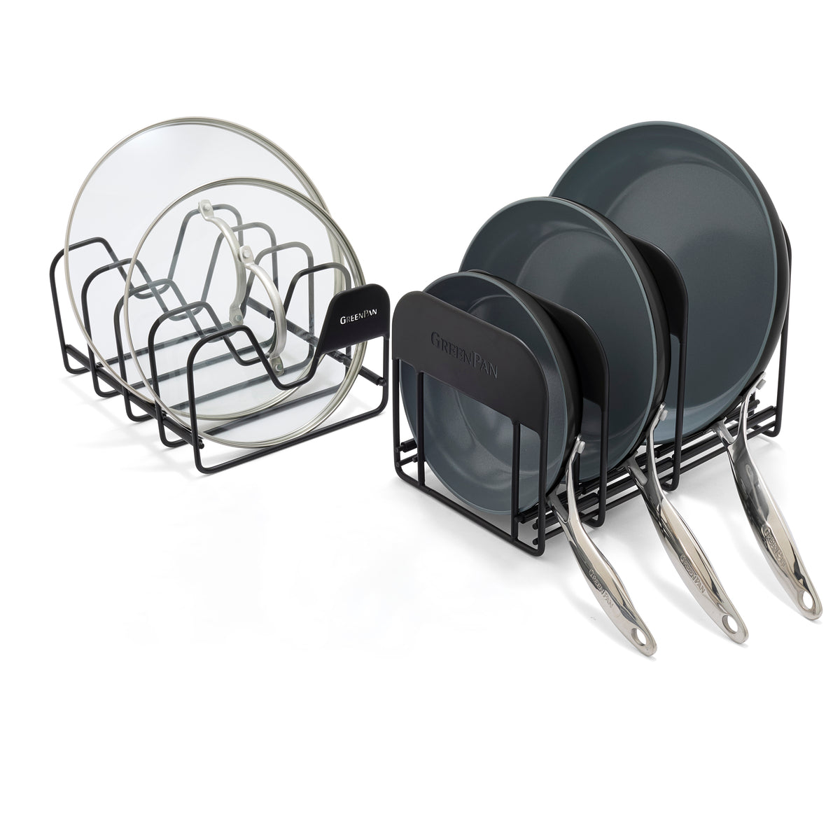 Two black metal racks organize glass lids and gray frypans, all arranged side by side on a neutral surface.