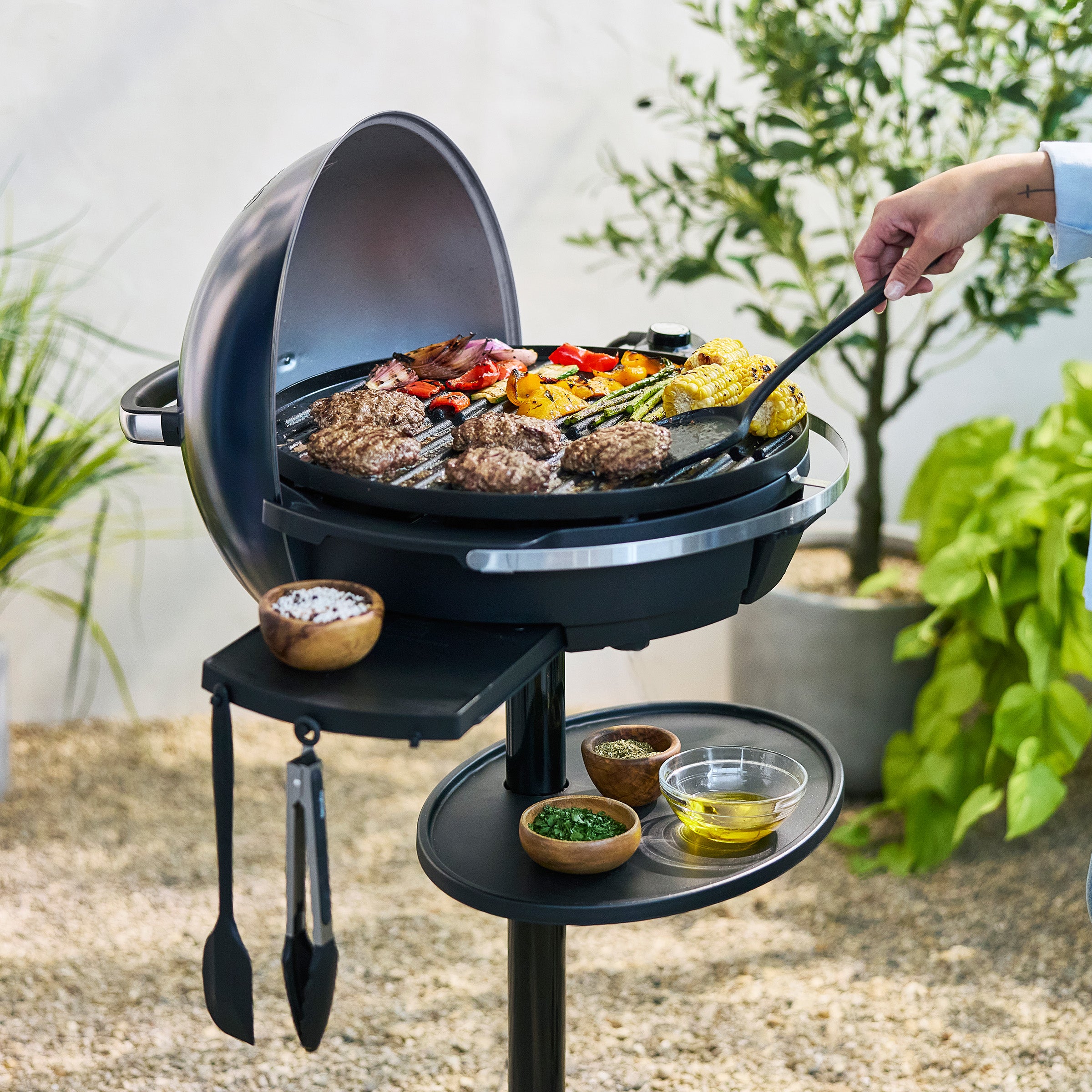 Portable grill with food being cooked outdoors