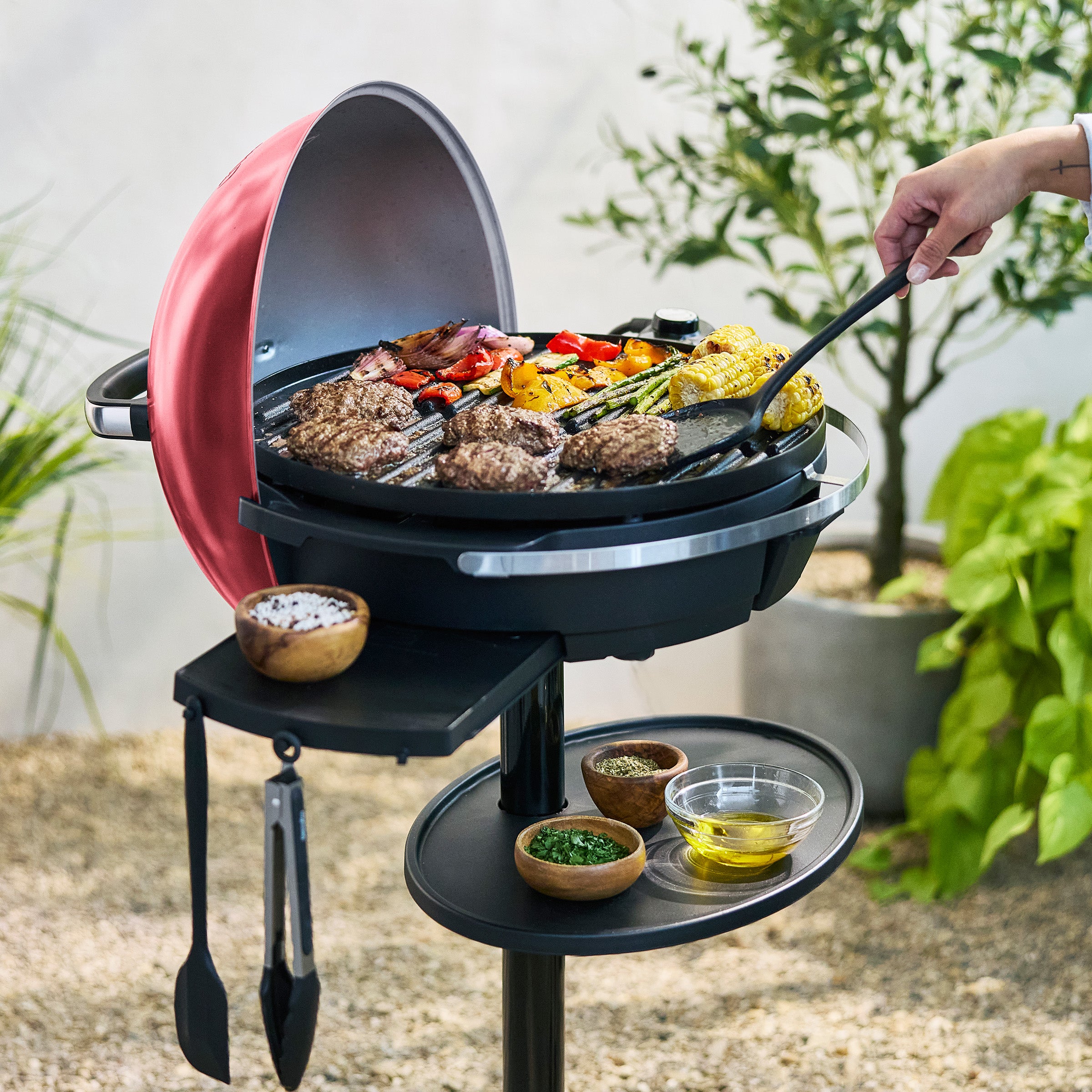 Portable grill with food being cooked outdoors