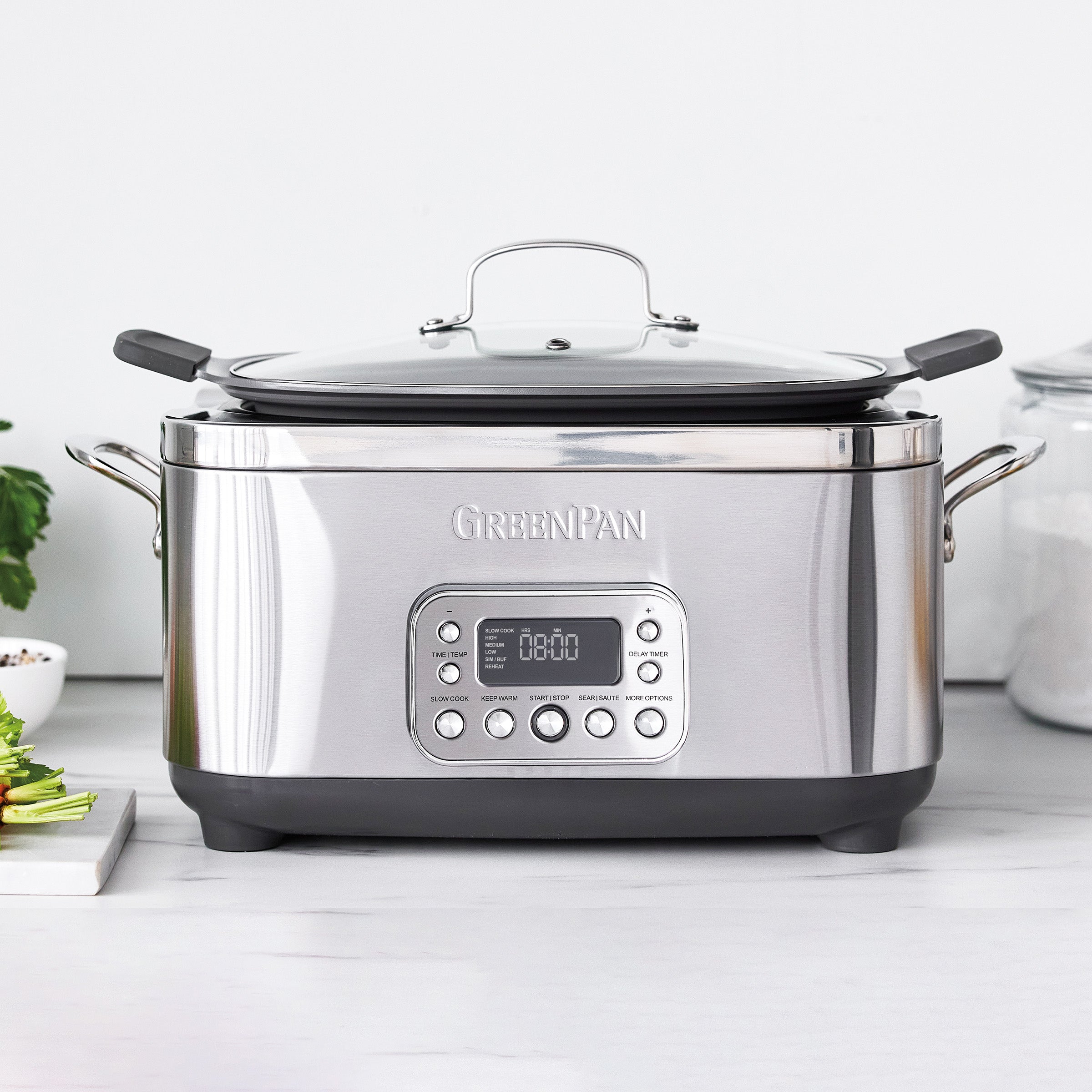 Stainless steel slow cooker with digital display on a white countertop