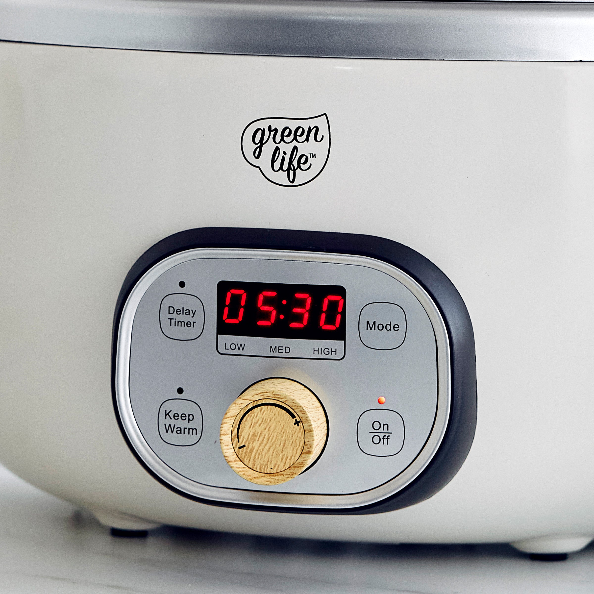 Control panel of a cream slow cooker with digital display and 'greenlife' branding.