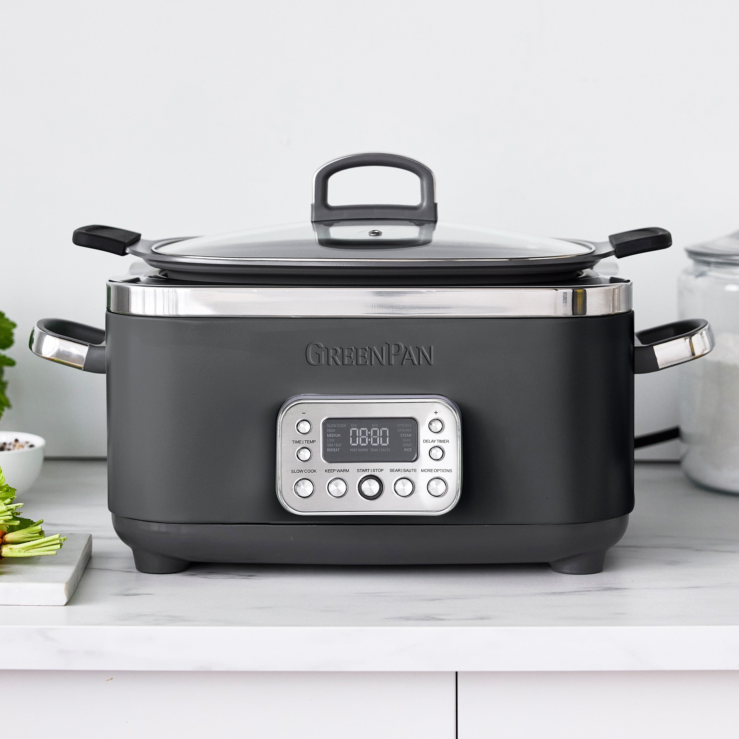 Gray slow cooker with digital display on a white countertop