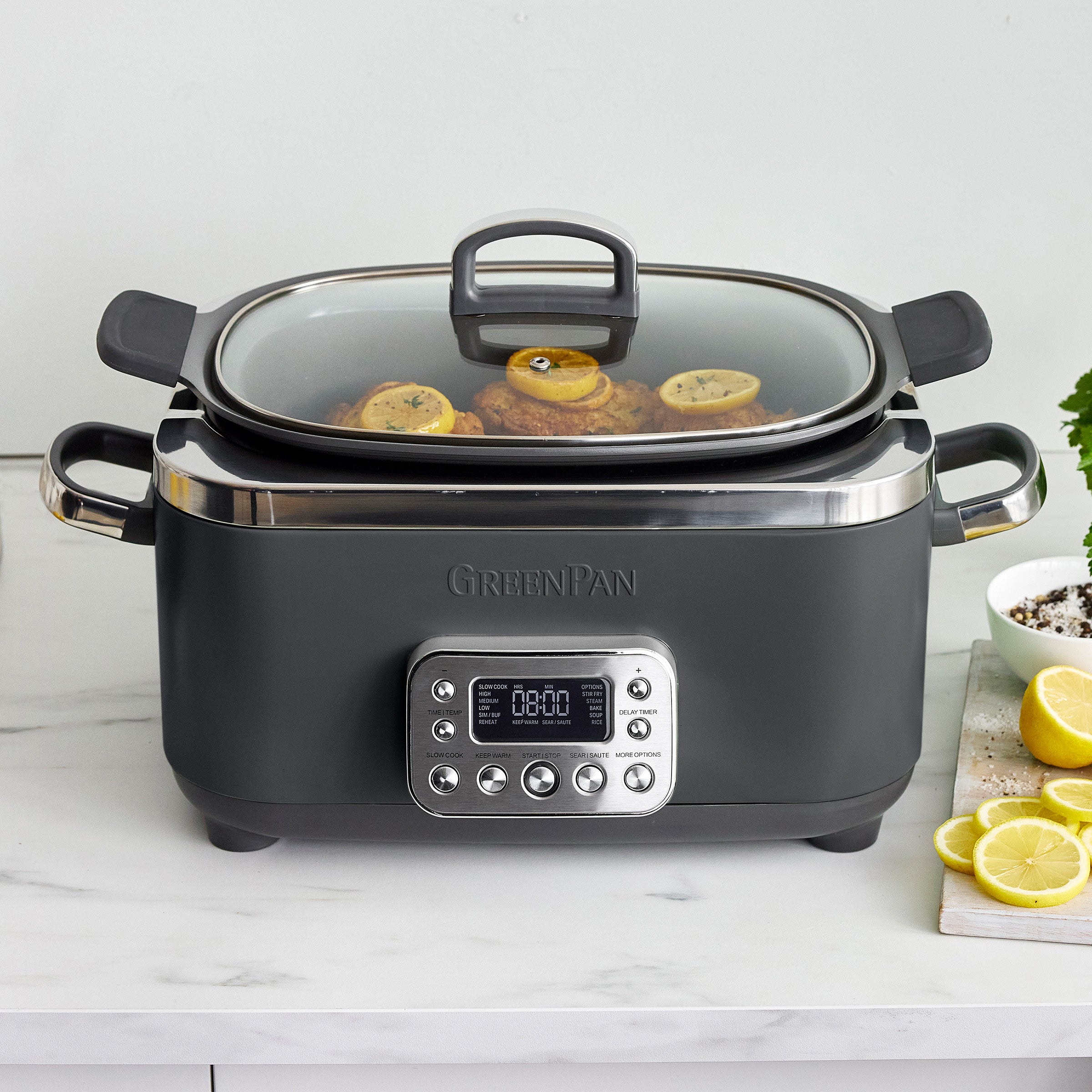 Gray slow cooker with digital display on a white countertop