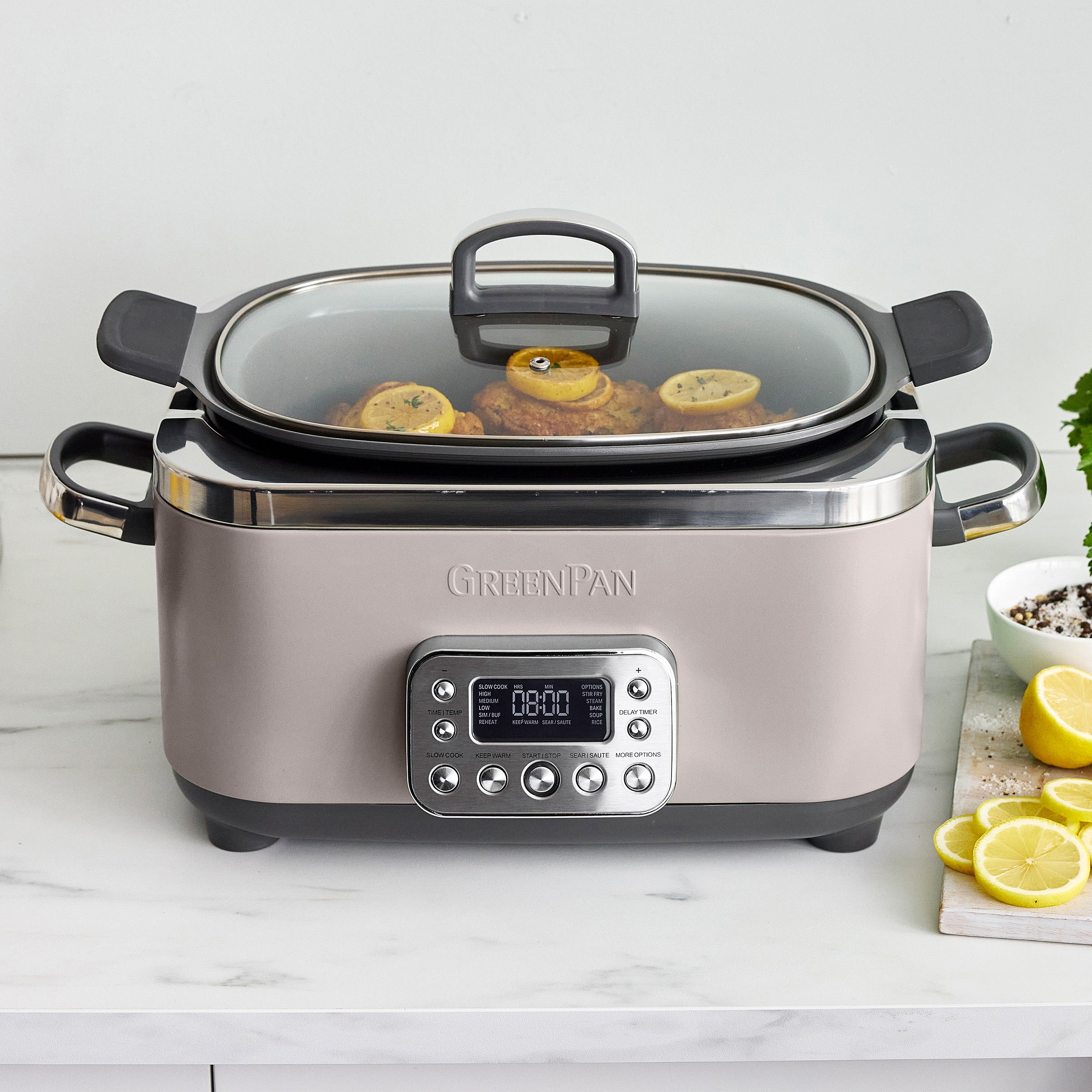 Taupe slow cooker with digital display on a white countertop