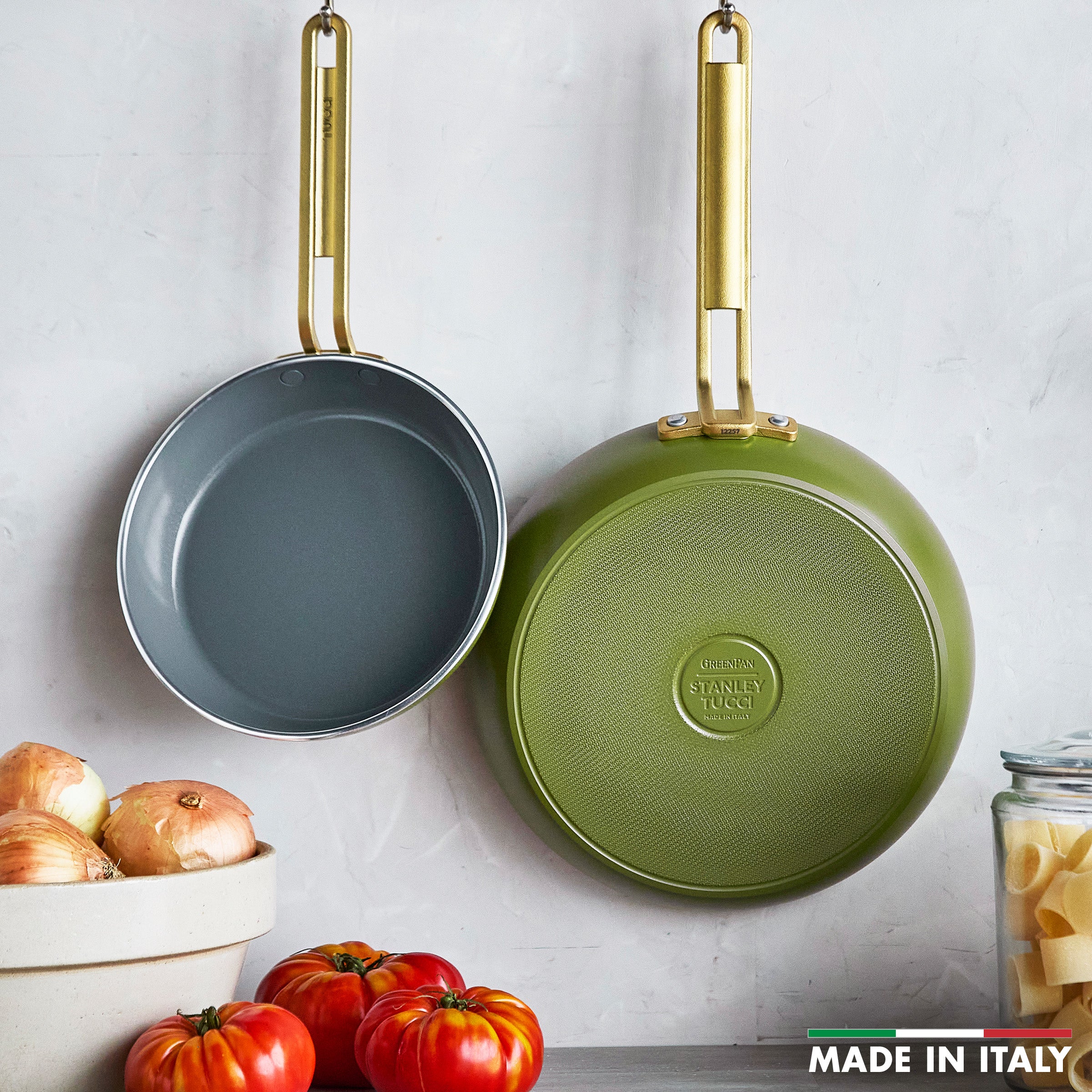 Two green frying pan with 'Stanley Tucci' branding on a white background.