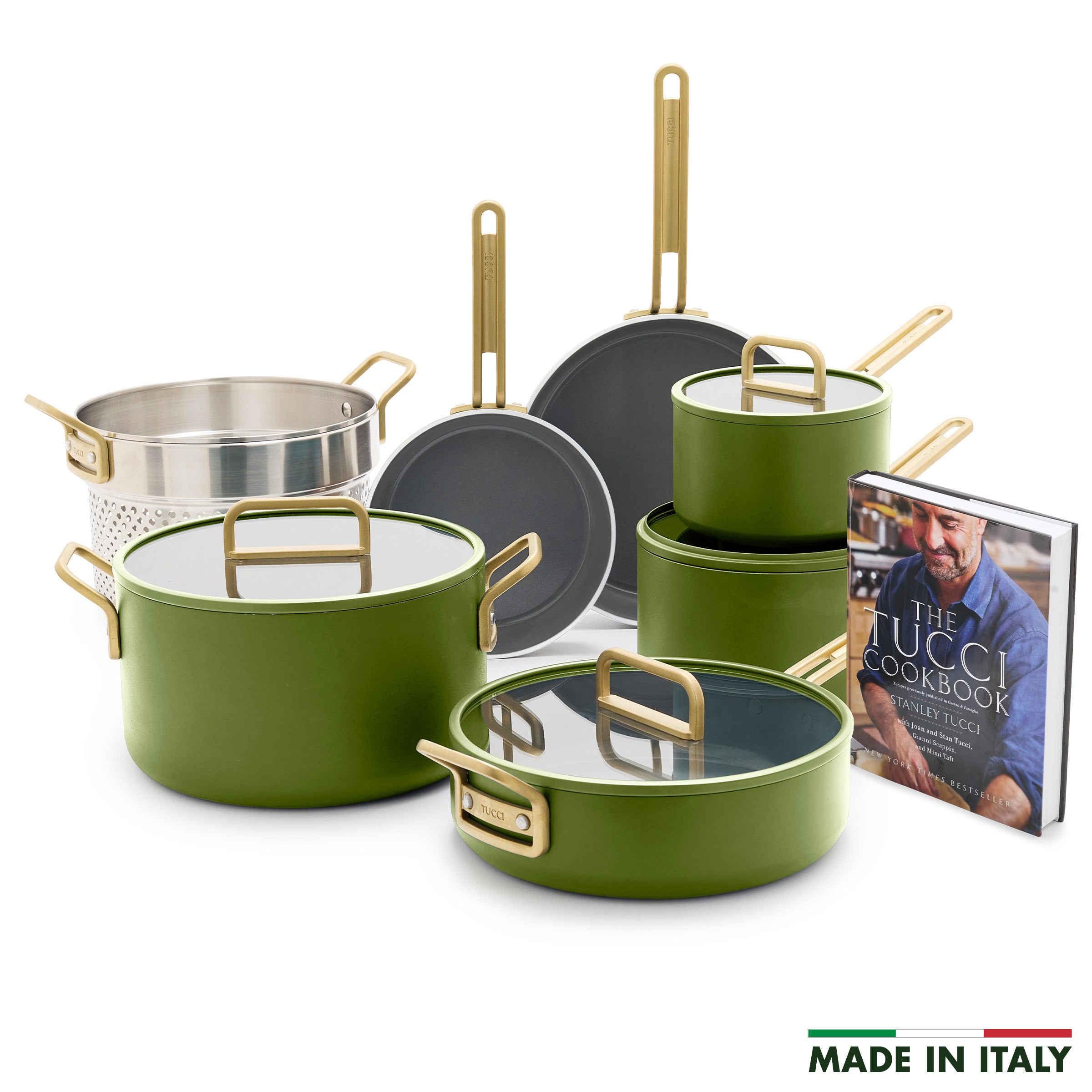Set of green cookware with gold handles and a cookbook titled 'The Tucci Cookbook' on a white background.
