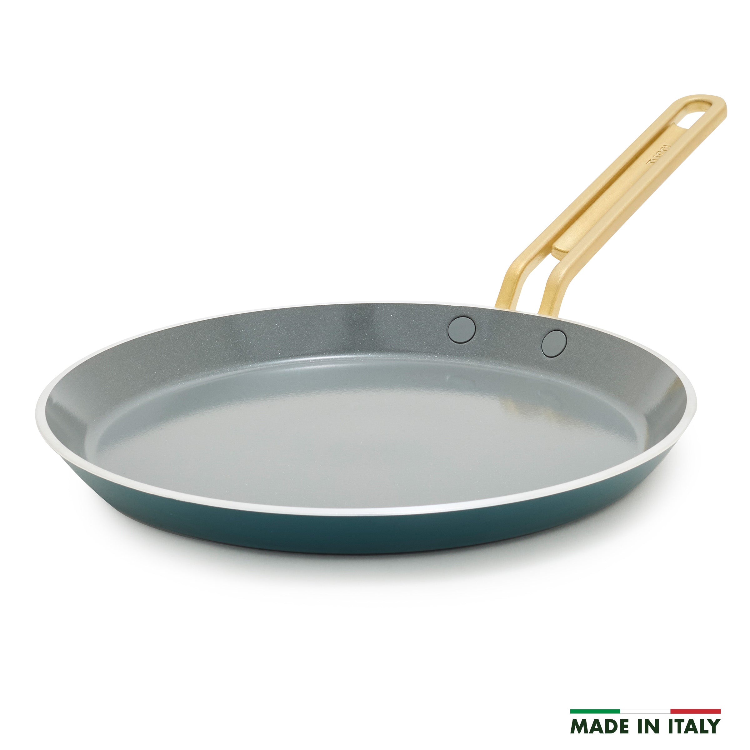 Teal crepe pan with a gold handle on a white background