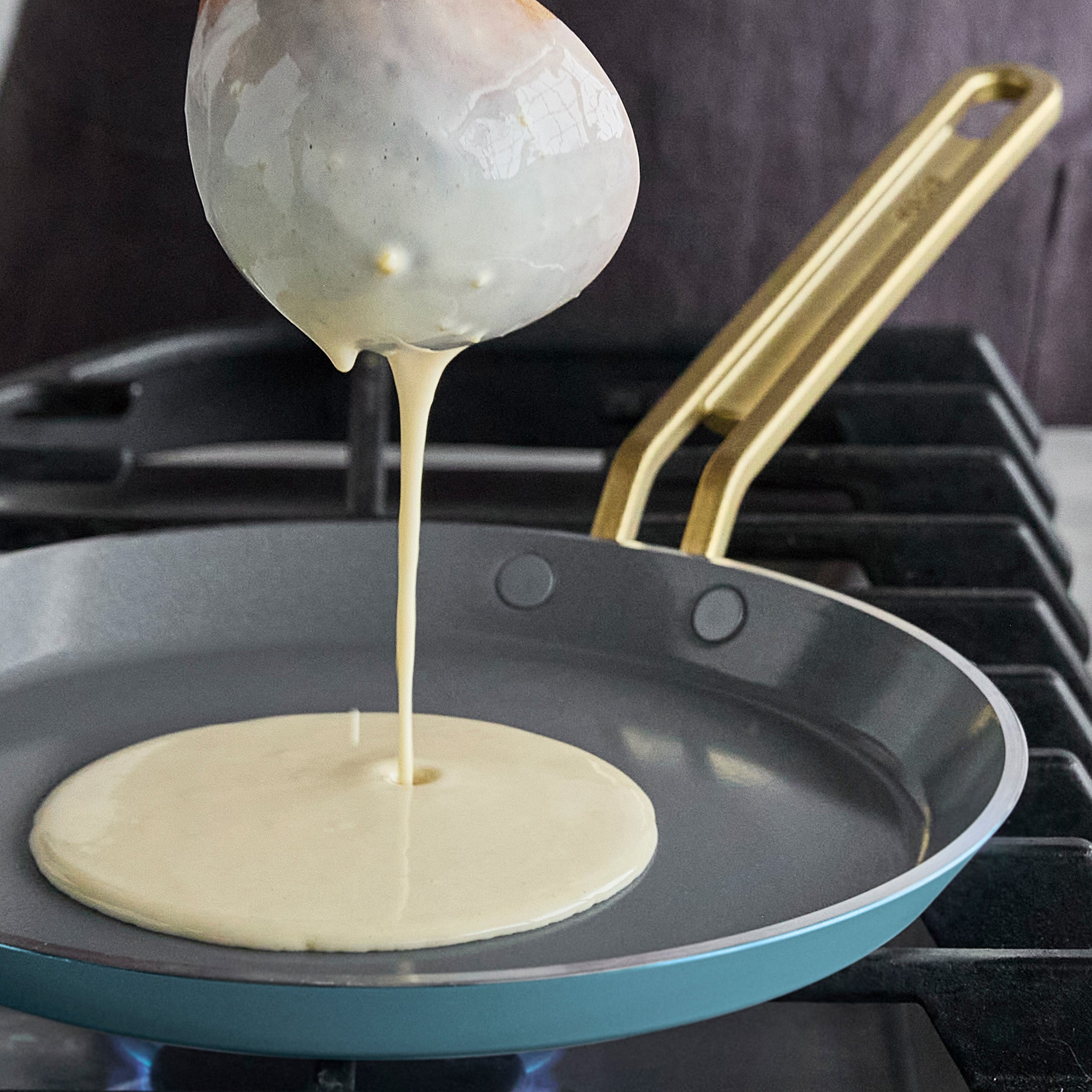 Crepe batter being poured onto a hot pan