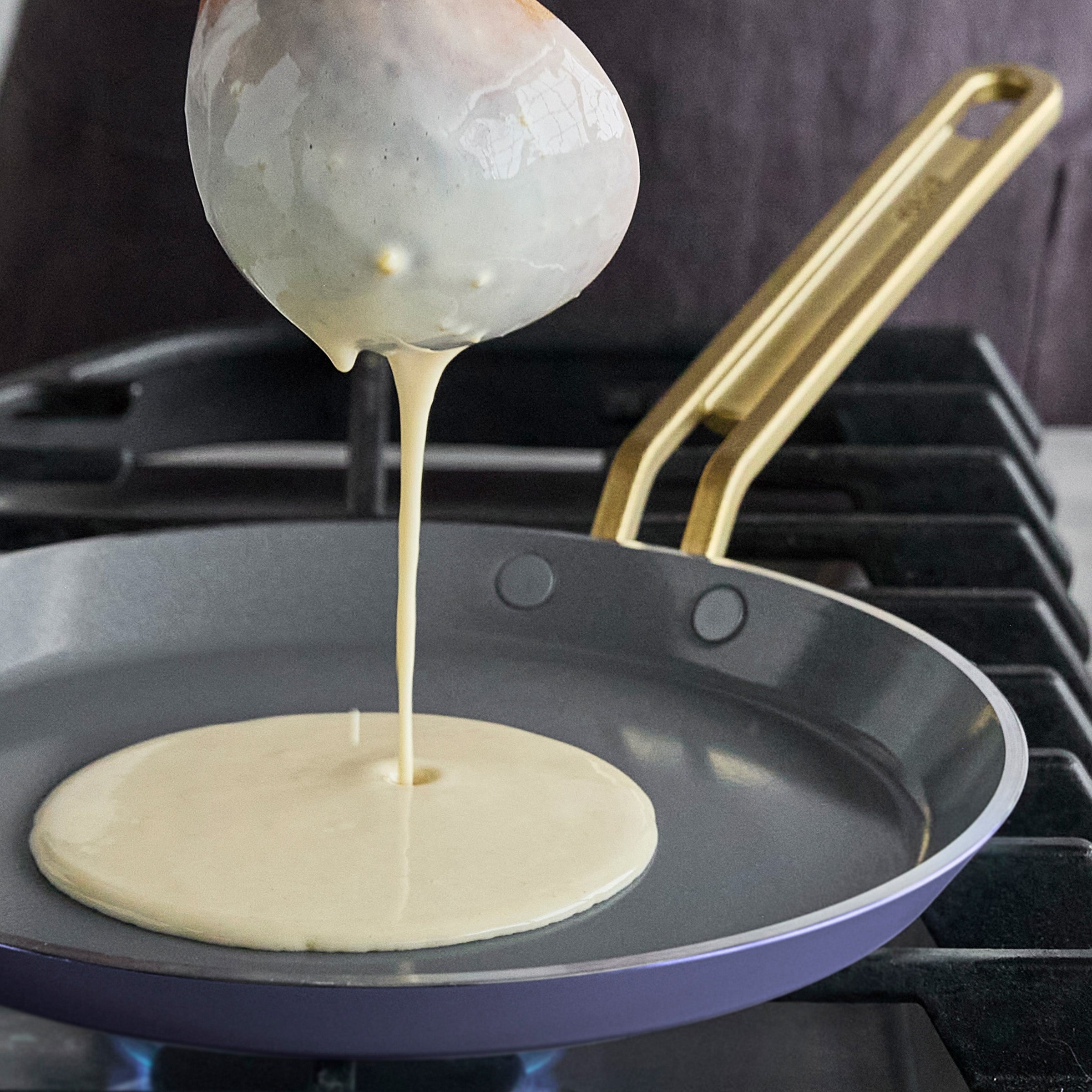 Crepe batter being poured onto a hot pan
