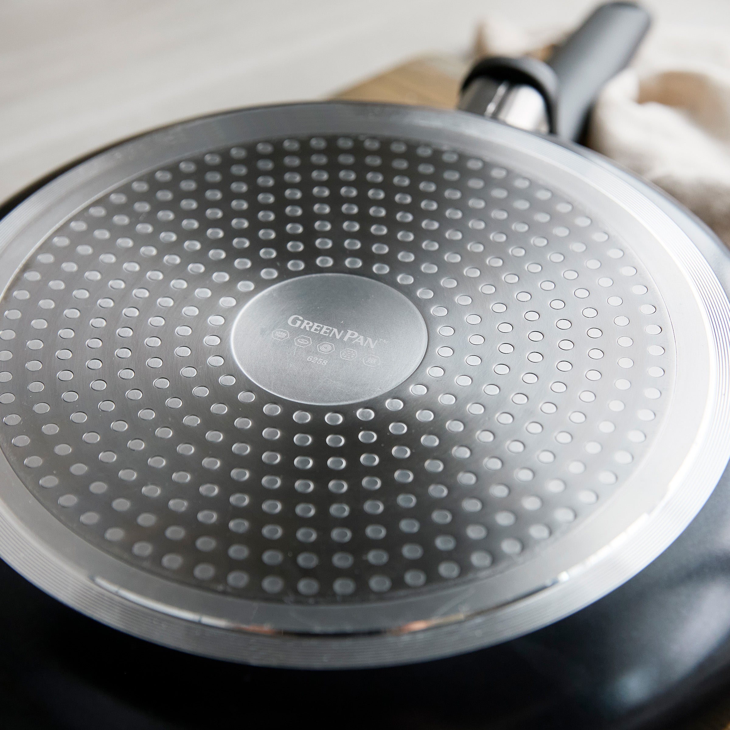 Rio ceramic nonstick 12-inch frypan base with a circular, induction-ready pattern and subtle brand marking visible.