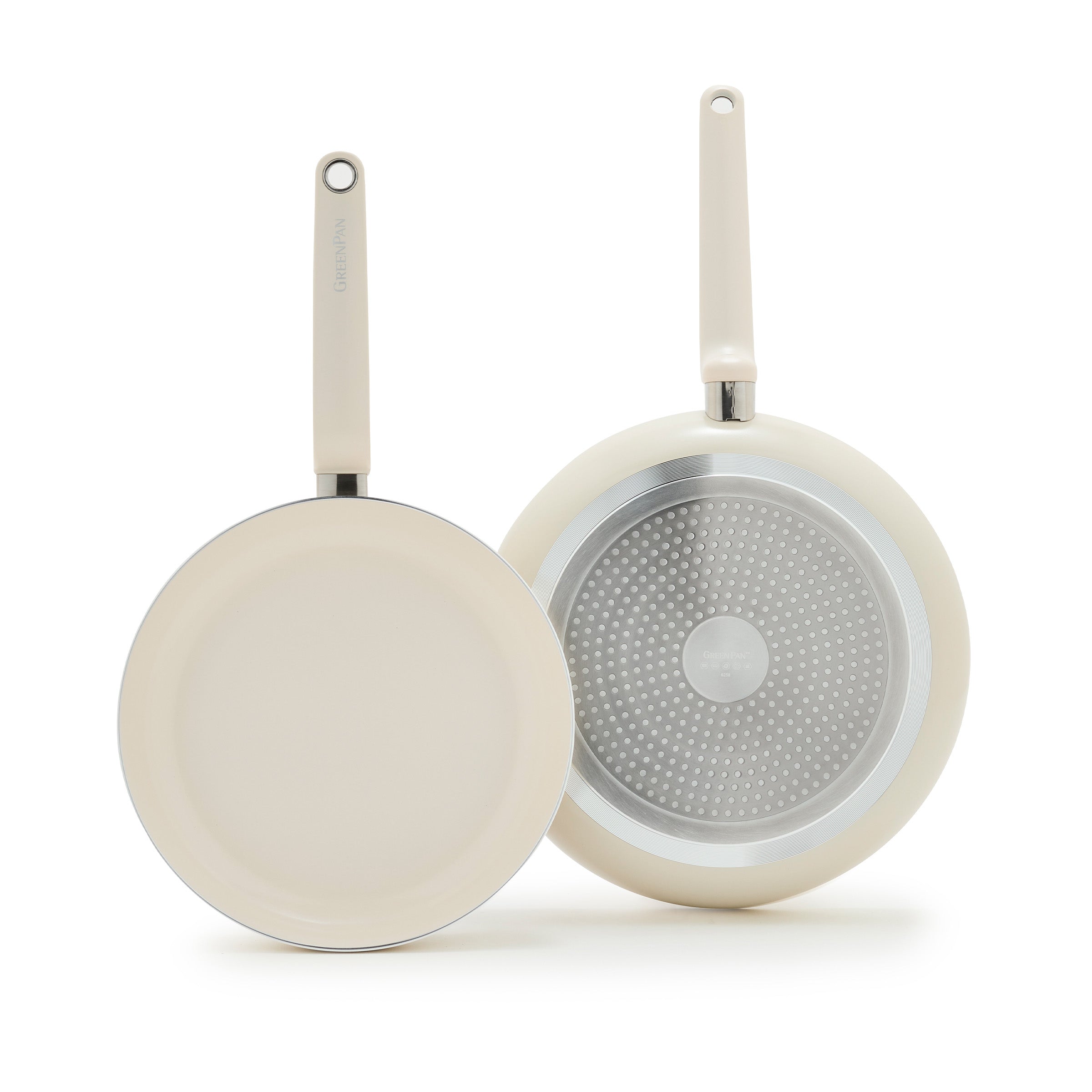 Set of two cream ceramic frypans, 10-inch and 12-inch, with cream interiors and metallic induction bases.