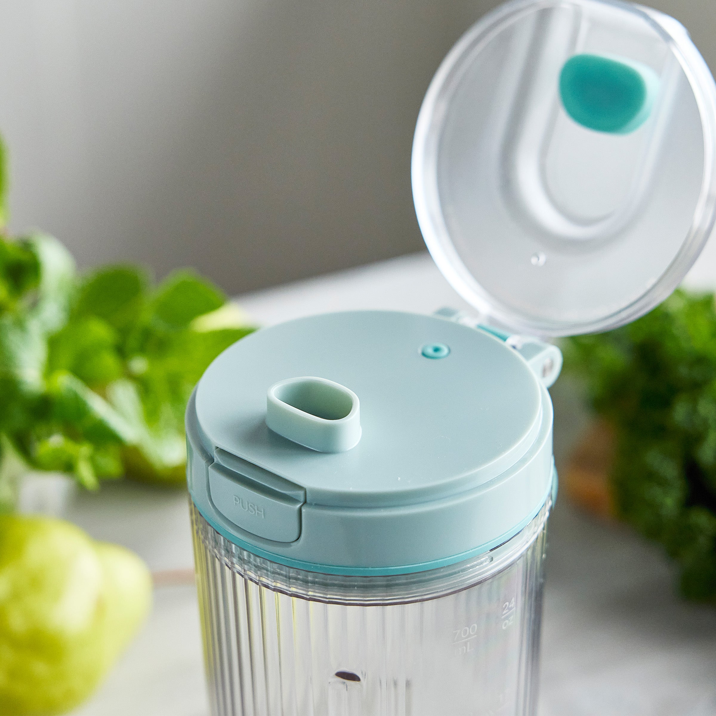 Clear container with blue lid and top on a light gray background