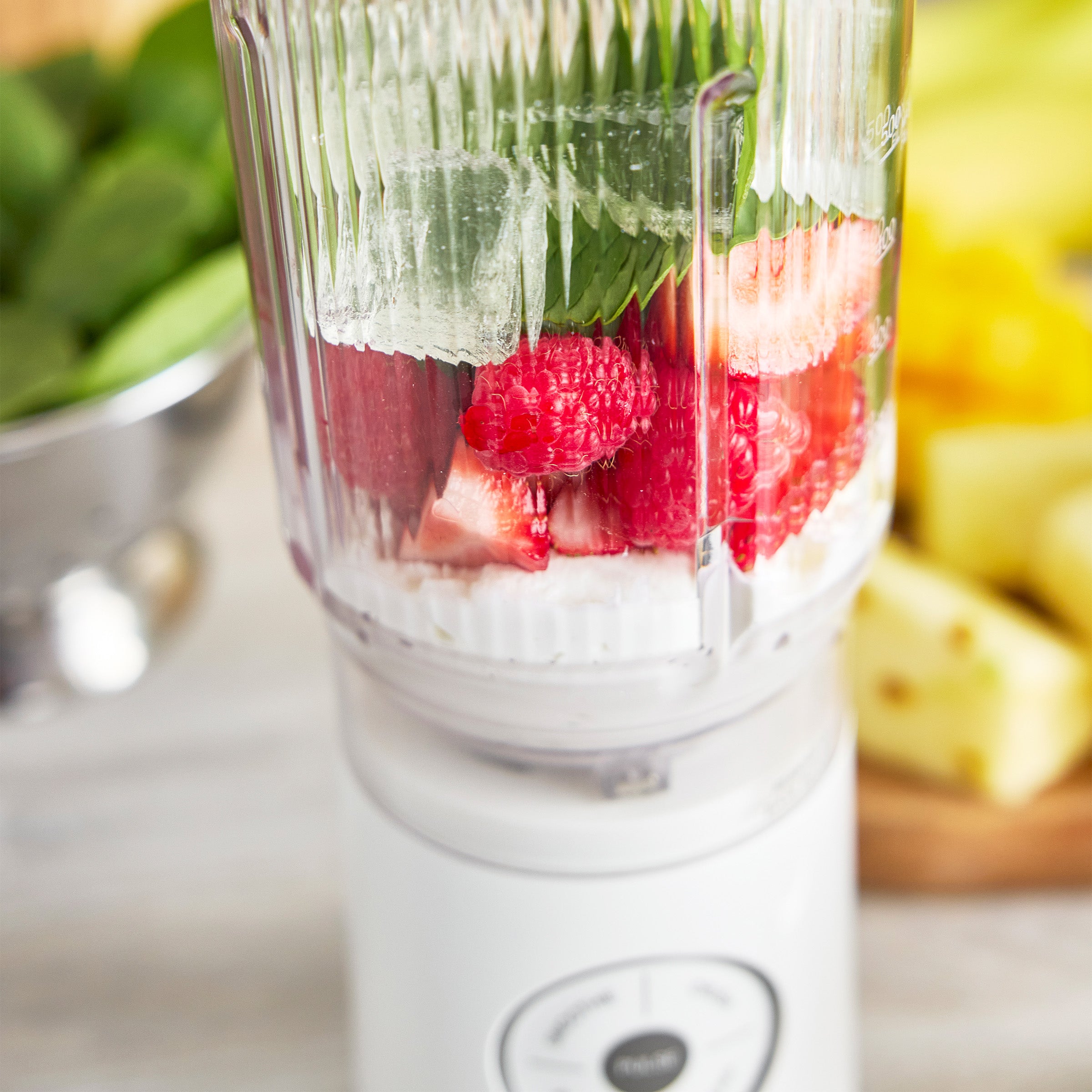 Blender with ingredients for a smoothie on a kitchen counter