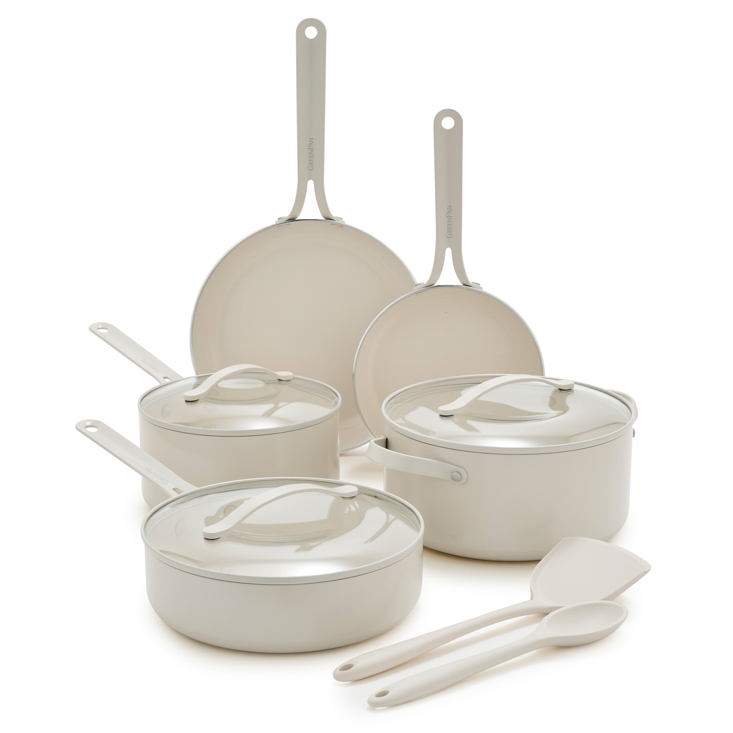 Set of cream cookware with lids and utensils on a white background