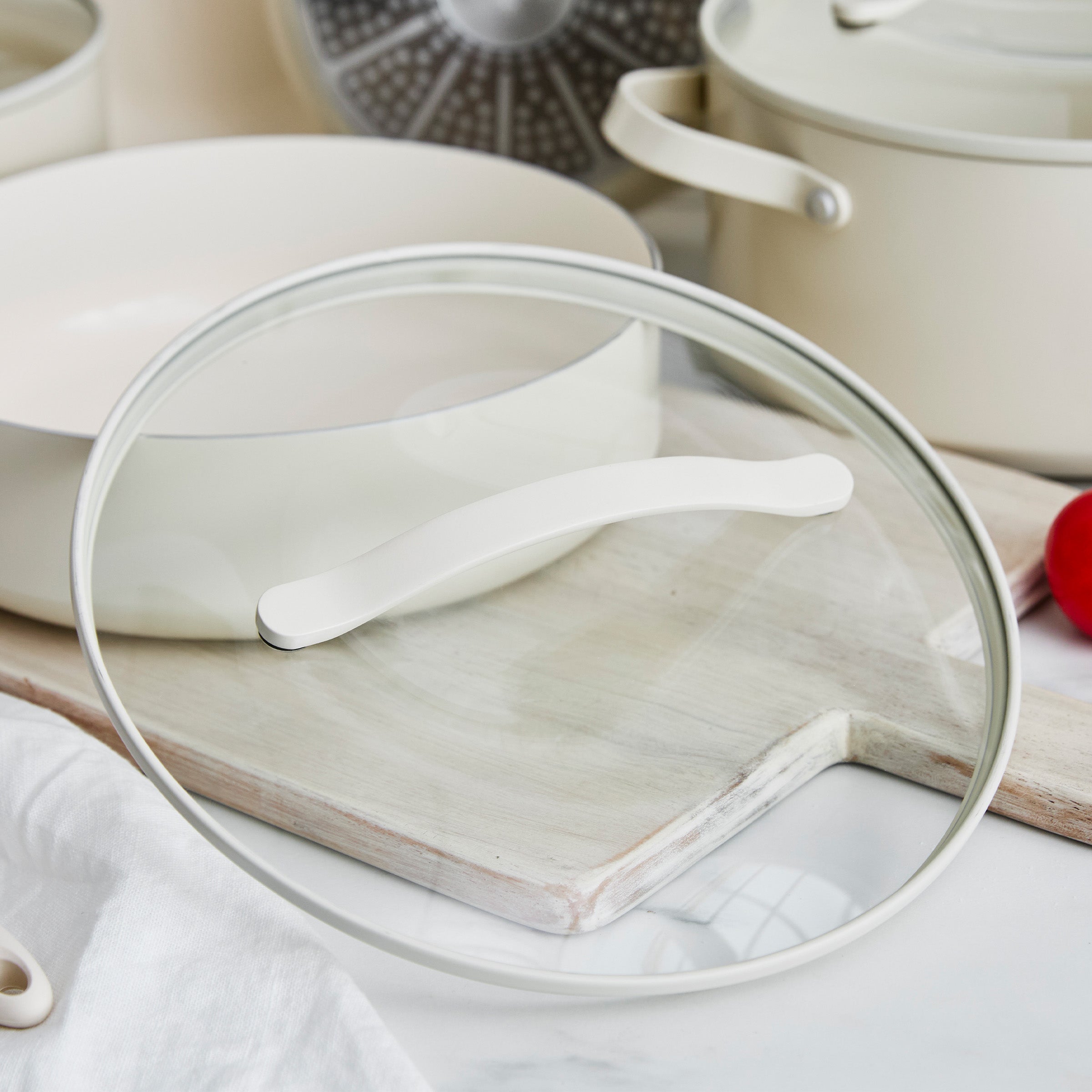 Cream pan with a glass lid on a wooden surface